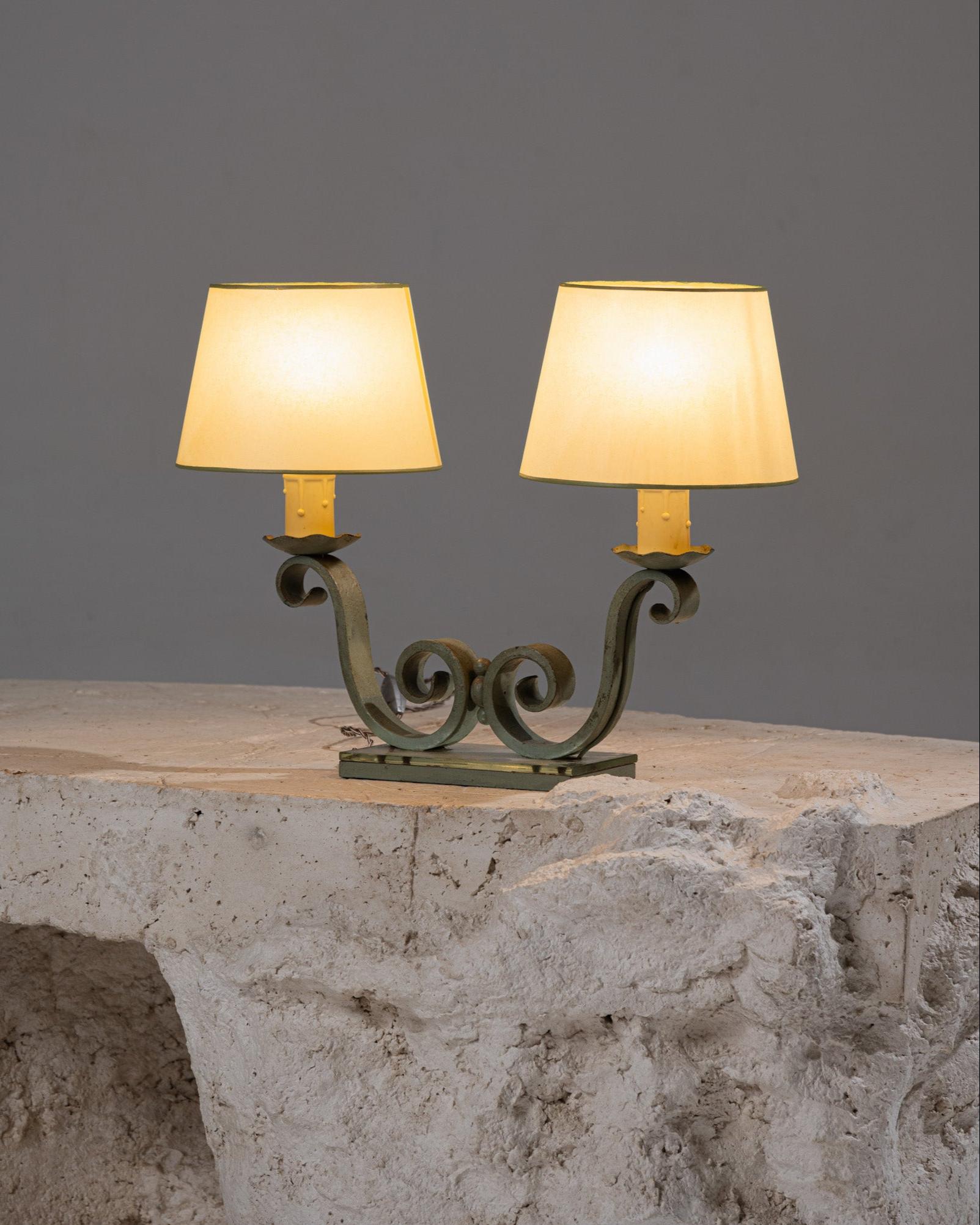 Table Lamp with Two Shades, featuring a green-patinated bronze structure on a mirrored base. The two sockets are designed with candle-style detailing. Original bayonet wiring, in working condition. Original lampshades included; very good overall