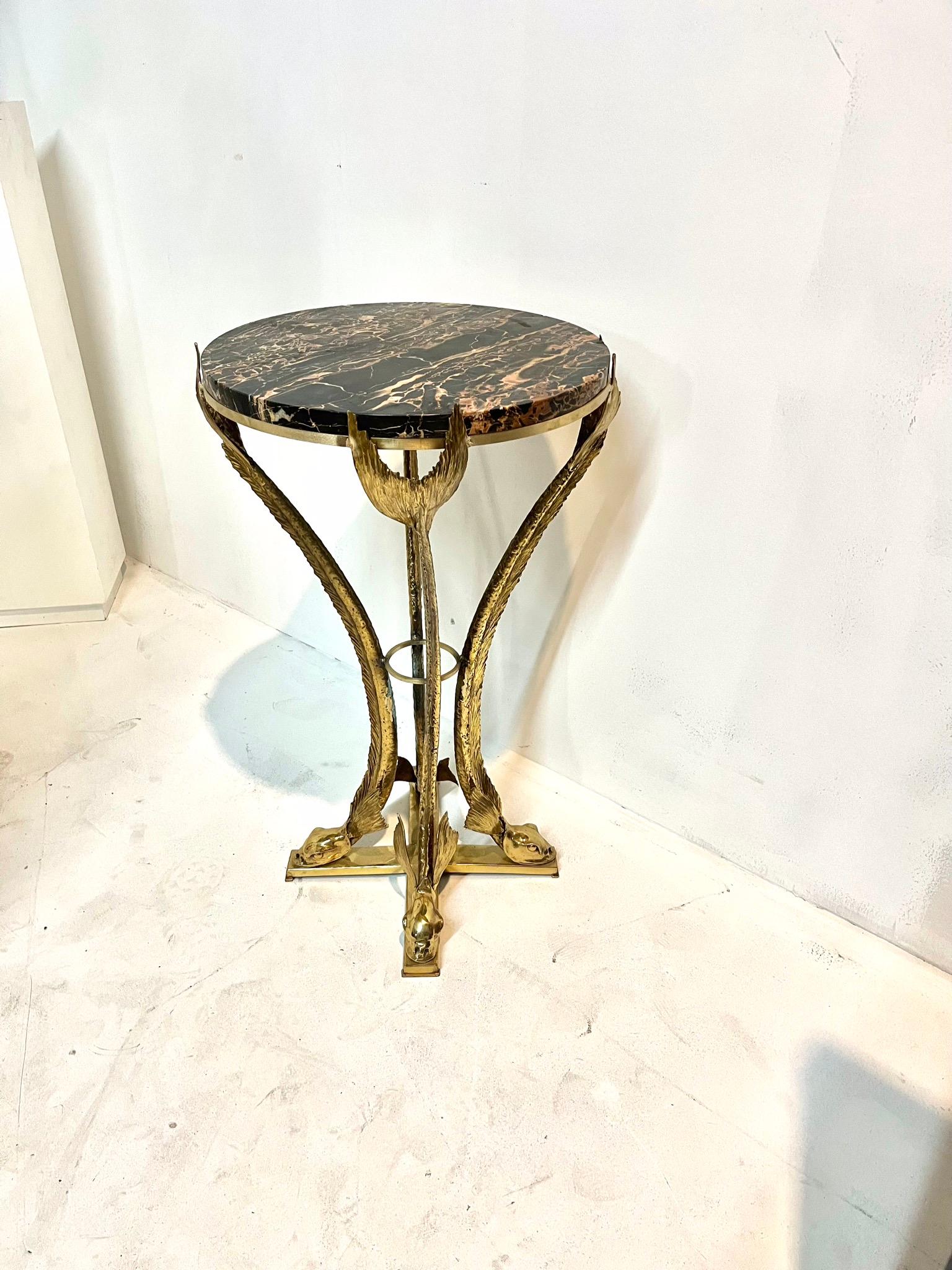 Elegant bronze and marble top for this sculptural Gueridon by Jacques Duval Brasseur.
Four stylized Tritons supporting a portor marble top.
Fabulous design, precious elements all together for this work of art by the French Sculptor Jacques Duval