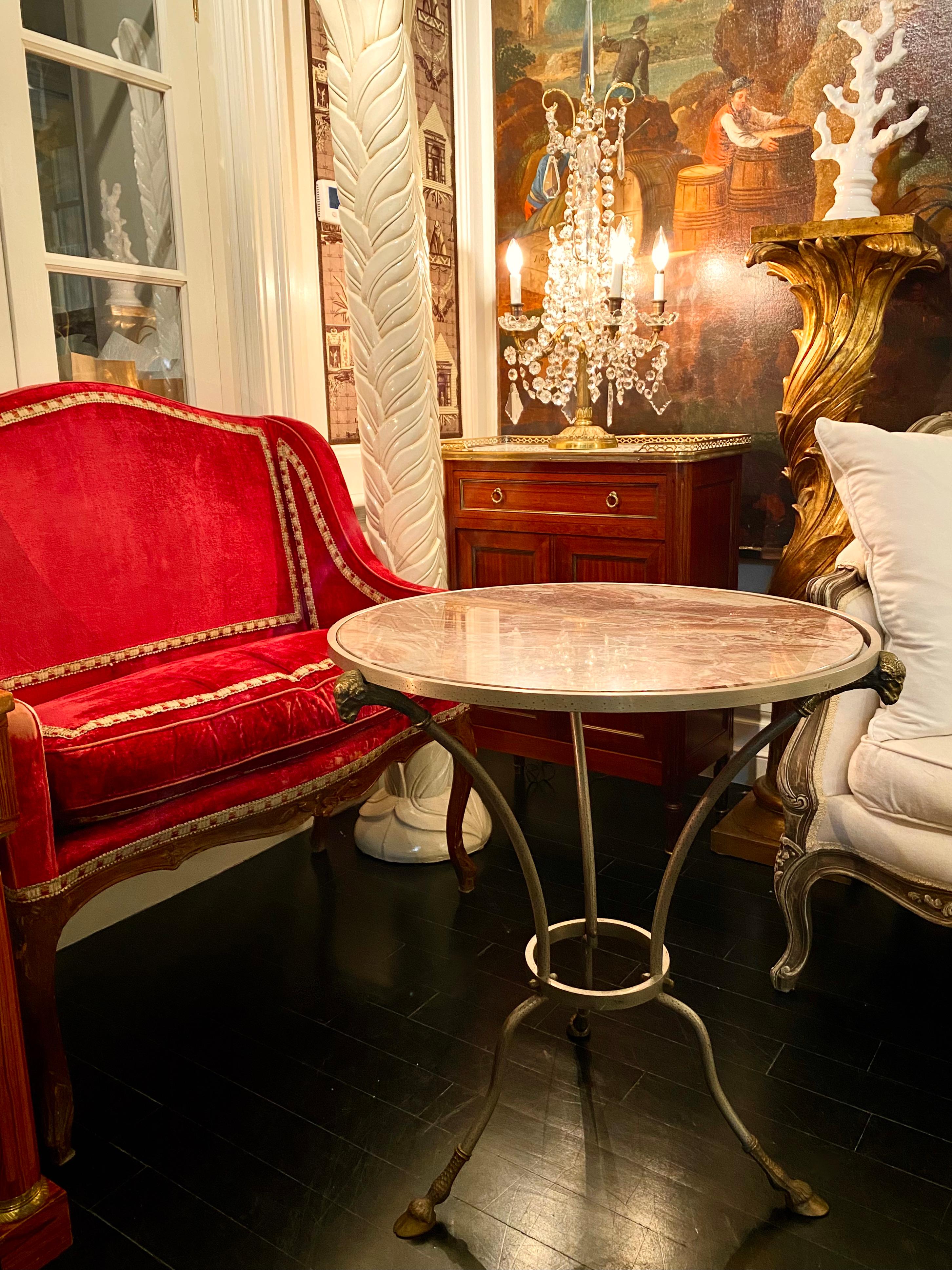 Bronze and red marble Empire style Gueridon table

A classic French bronze and red marble round gueridon table on scrolled legs with hoof (sabot) feet on casters. Topped by a rare and stunning red and cream marble as appears from the various