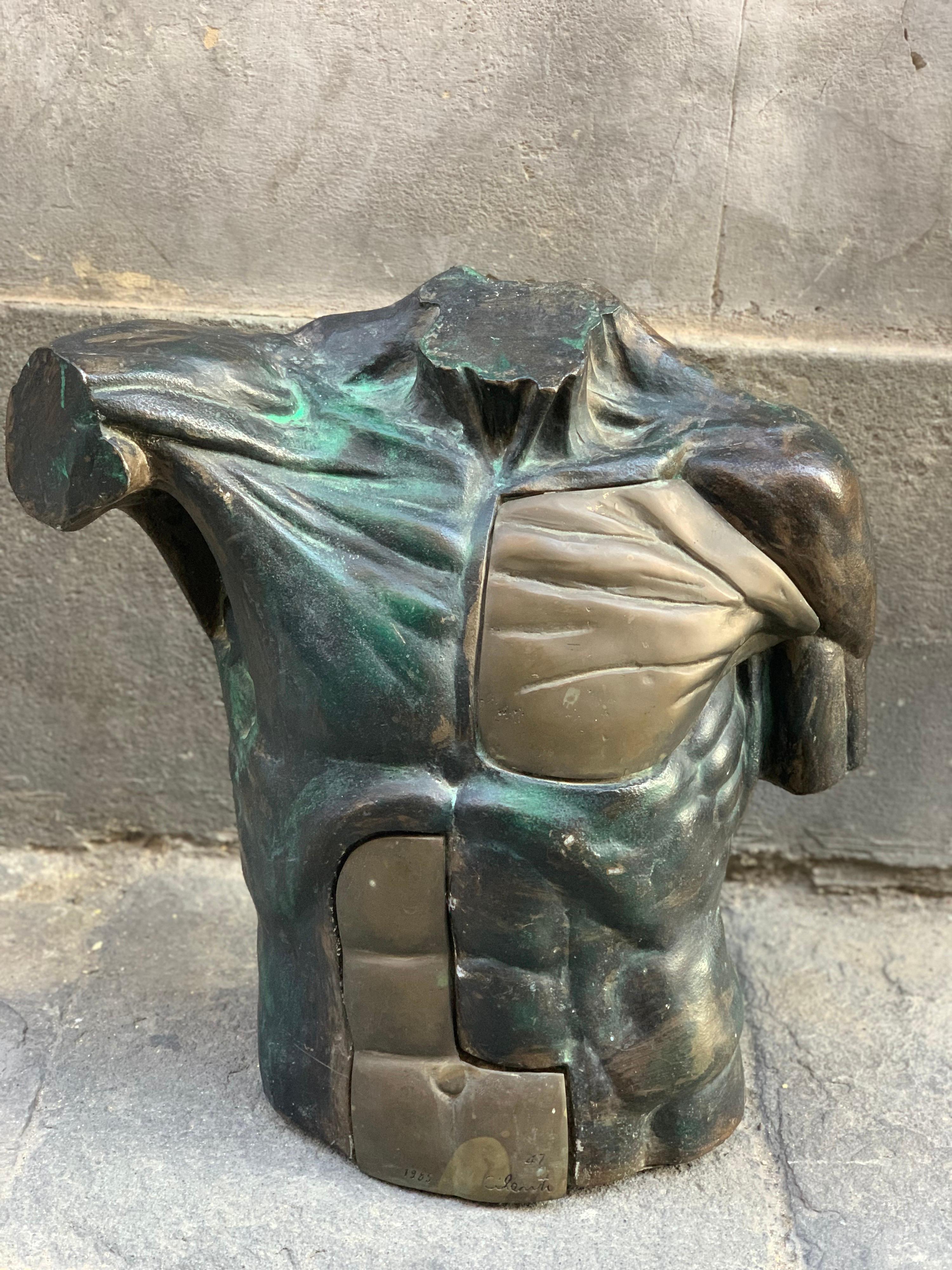 Bronze and Resin Bust of a man, Signed by Cilenti, 1985. 
Part of the the abdomen and pectoral muscles are in bronze, the remaining parts are in dark brown, green, black, and silver painted resin. The sculpture is heavy and powerful and expresses