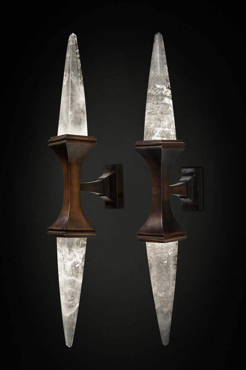 Rock crystal quartz wall light I, antique brass edition.
These wall sconces are handmade in bronze in Paris. Each workers who made this wall sconce belongs to a corporation and worked also for the most famous French companies (Haute Couture and
