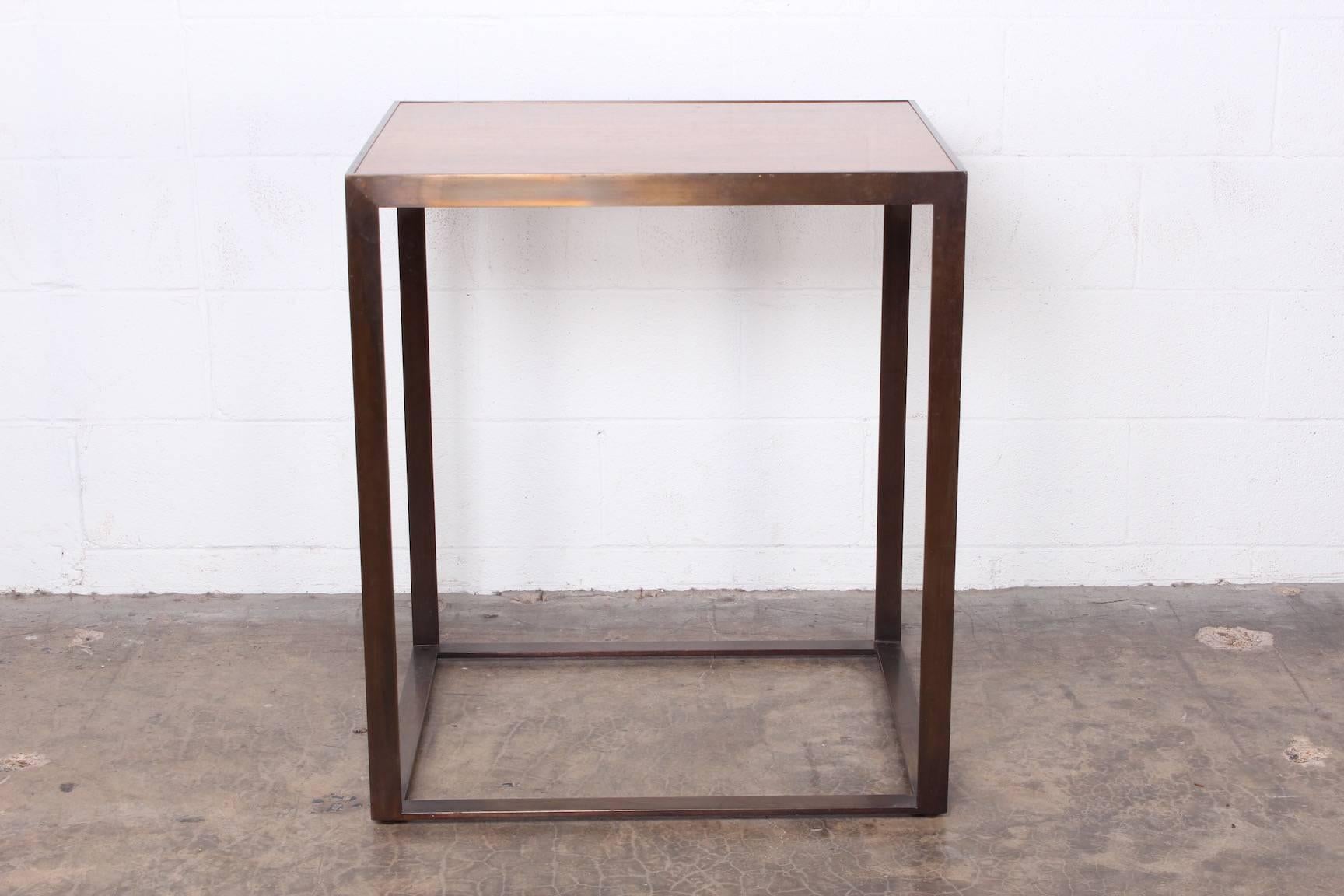 A large-scale pedestal made of solid bronze with inset rosewood top. Manufactured by Dunbar.