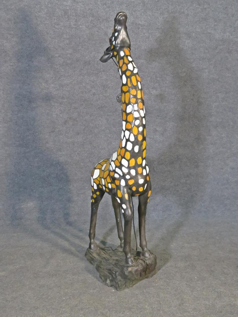 Unique and eye-catching giraffe sculpture cast in bronze with stained glass panels. A light inside the sculpture radiates out through the stained glass panels for a brilliant effect. Please confirm item location with seller (NY/NJ).