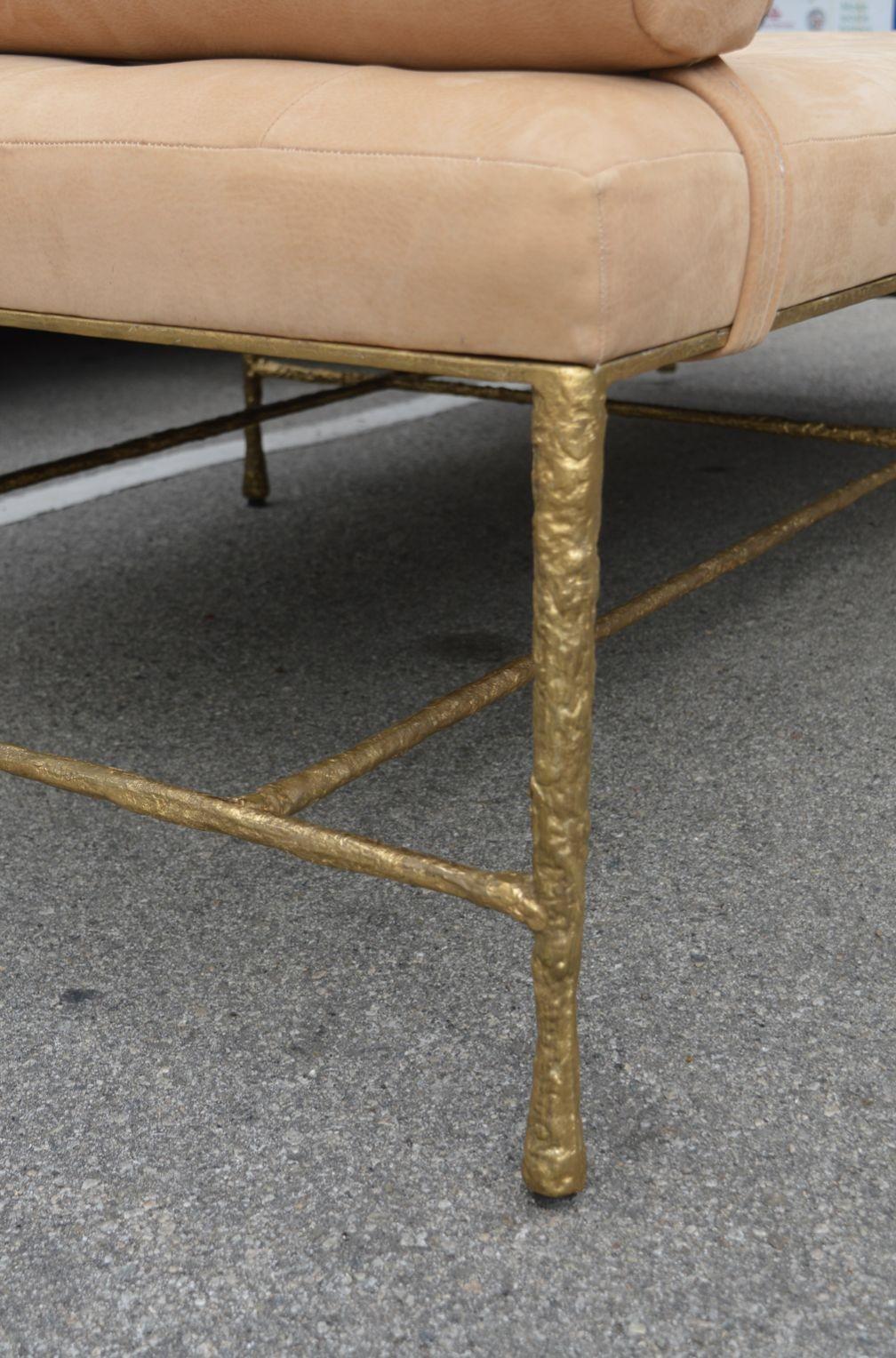 Day bed with solid bronze gilded base. The cushion could also be removed and this piece could serve as a large ottoman/coffee table. SUede upholstery in a tufted light tan color.
 
Dimensions:
 
25