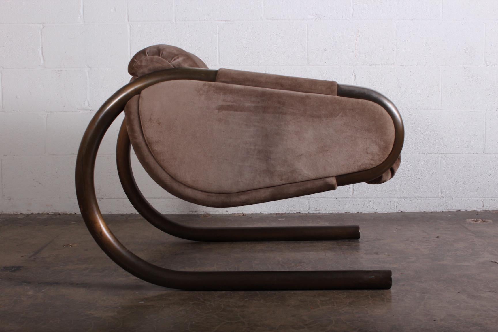 A large scale lounge chair with bronze plated frame and suede upholstery by Dunbar.