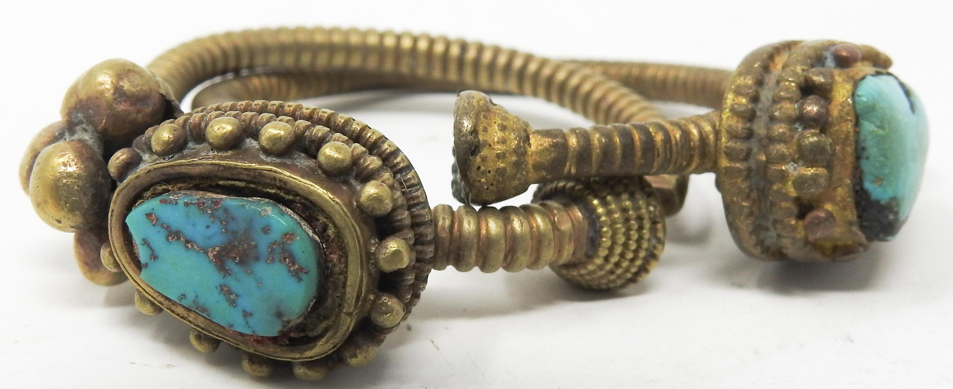 Offering this stunning pair of Tibetan bronze and turquoise clip-on earrings. The stones stand out against the aged bronze patina. These are handcrafted. The push together too close.