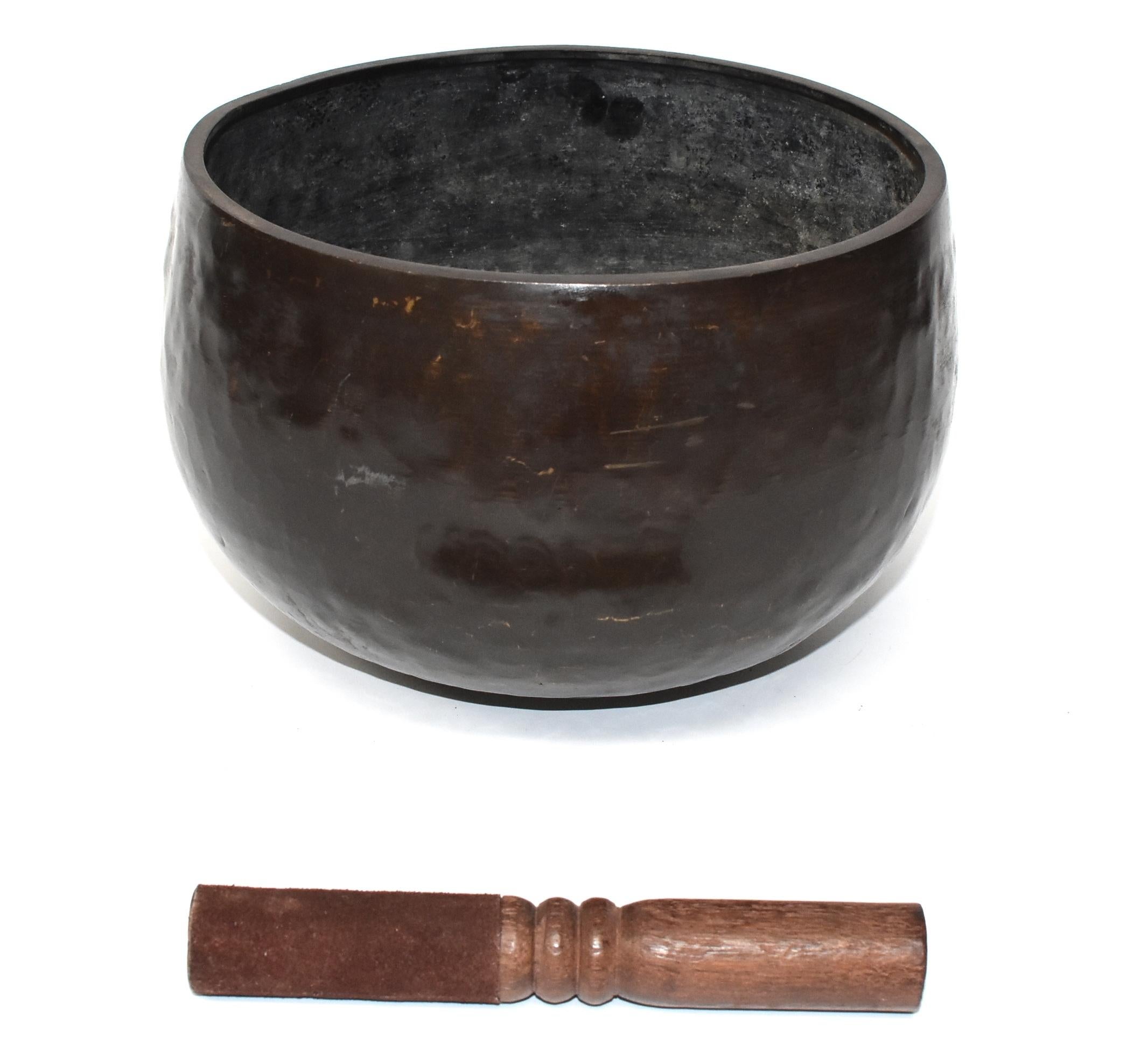 This is a large, substantial antique Japanese singing bowl in copper finish. The material is solid bronze. All patina is original. The beautiful beehive patterned dimples are hand-hammered. This bowl makes the most beautiful, enlightening, deep
