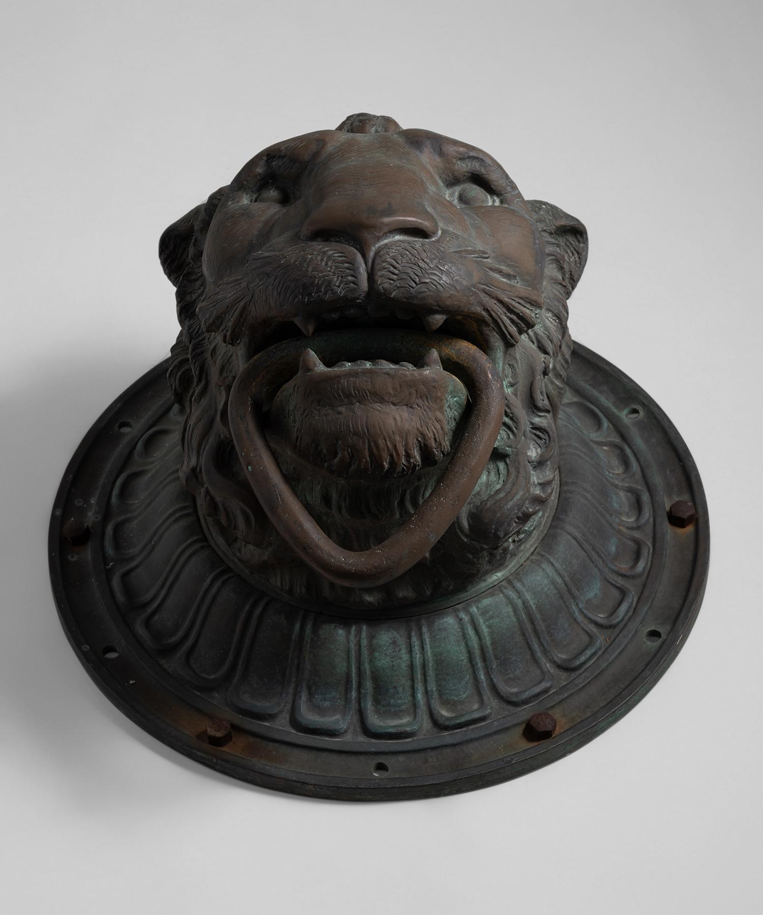 Massive cast bronze door knocker with finely carved details and convex circular plate.


Measures: 22