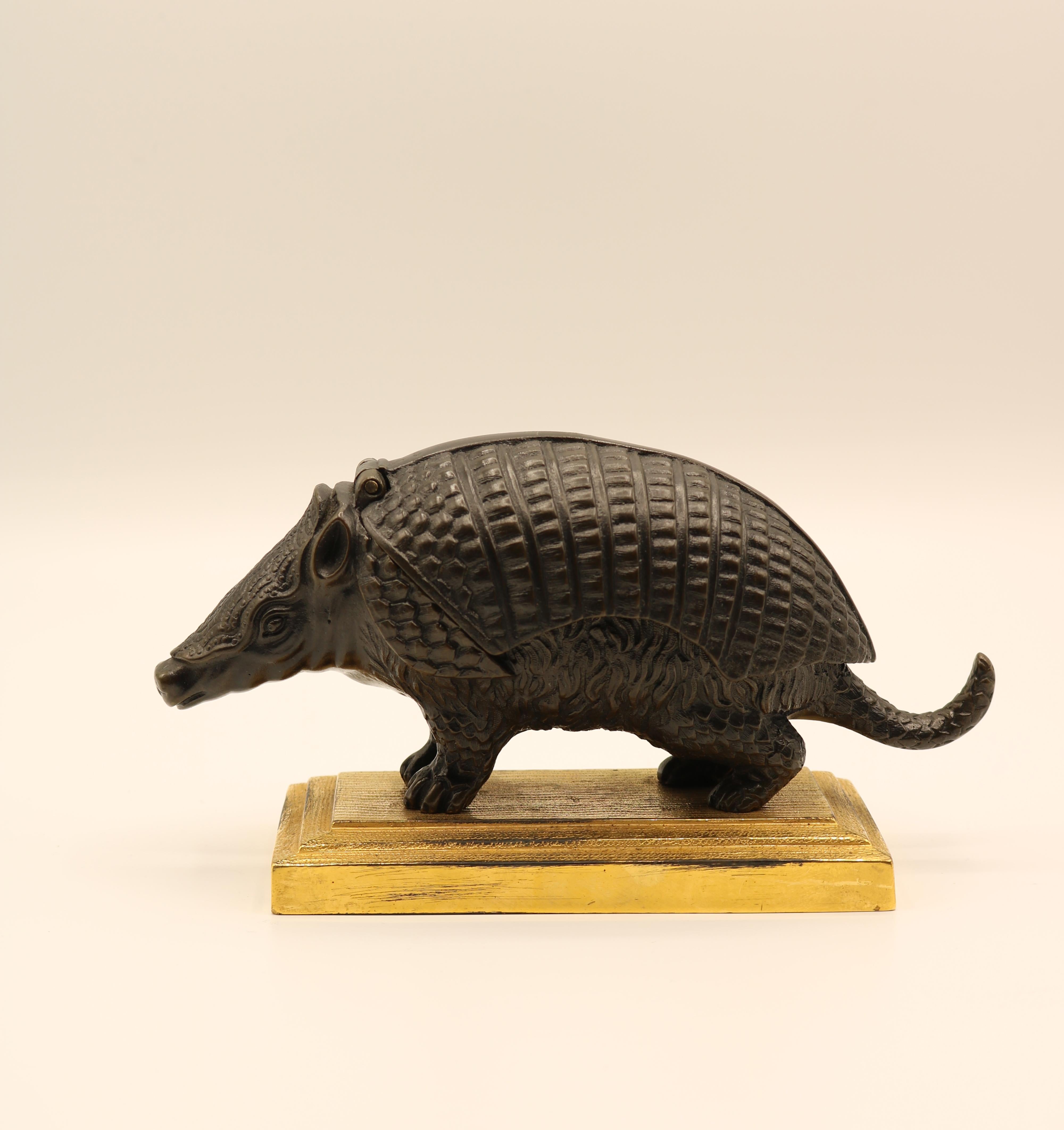 A well-cast mid-19th century model of an Armadillo, the shell-hinged lid enclosing two inkwells, raised on an ormolu stepped moulded edged platform base.