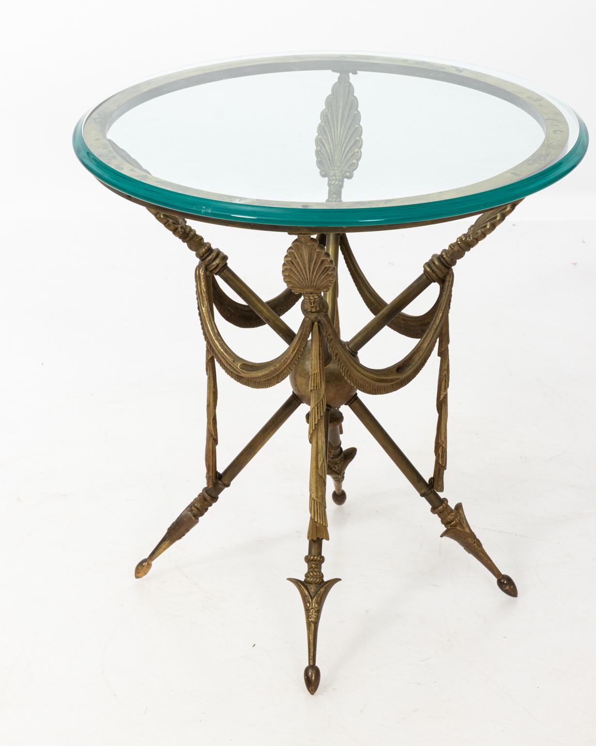 Bronze size table with glass top and arrow base. Please note of wear consistent with age including patina and minor oxidation.