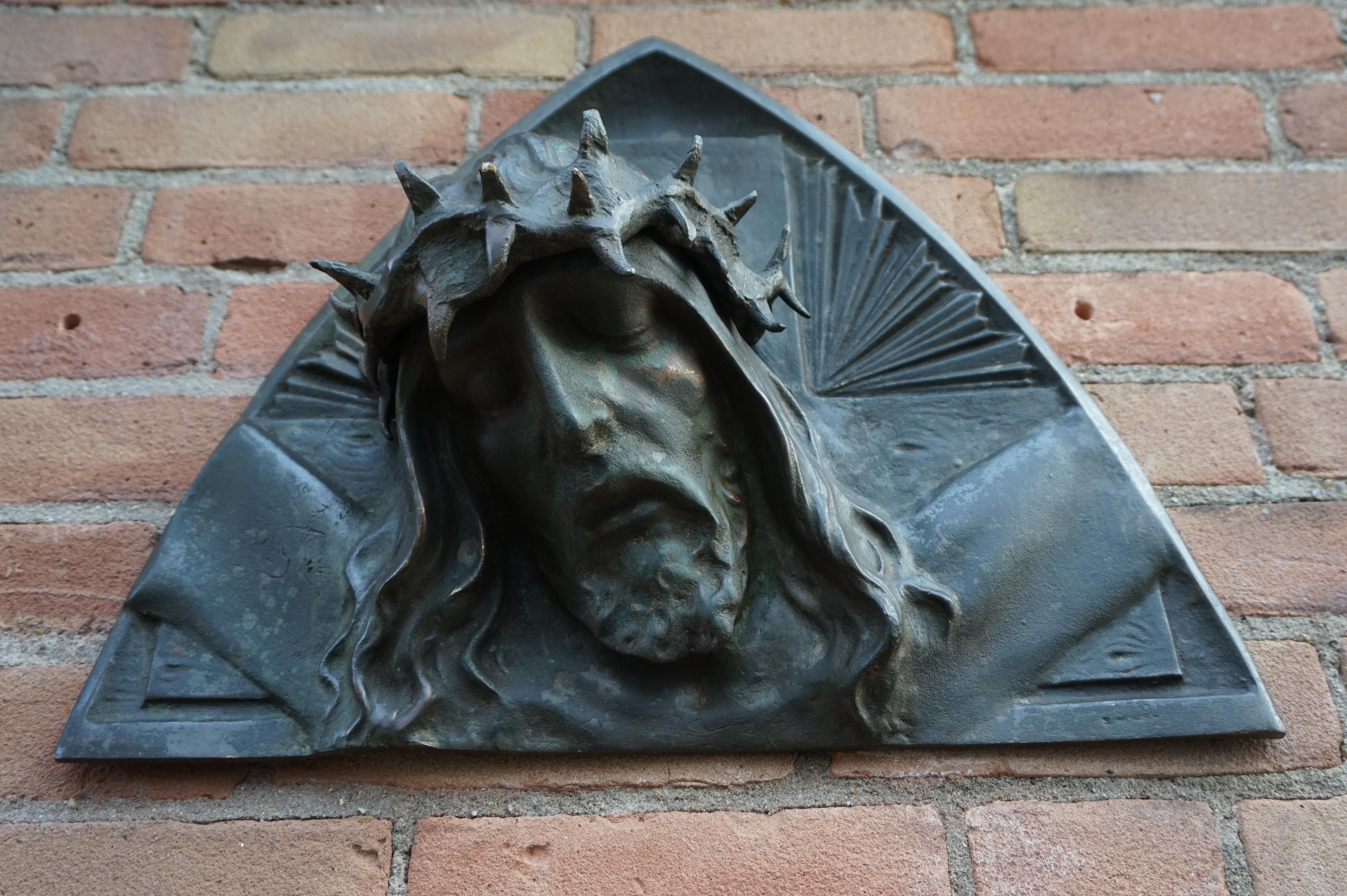 Impressive and sizeable sculpture of Christ with a gruesome crown of thorns.

This striking sculpture of Christ on a rounded, triangle wall plaque dates from the 1920s. It actually is the deepest in relief by Sylvain Norga that we ever saw. With