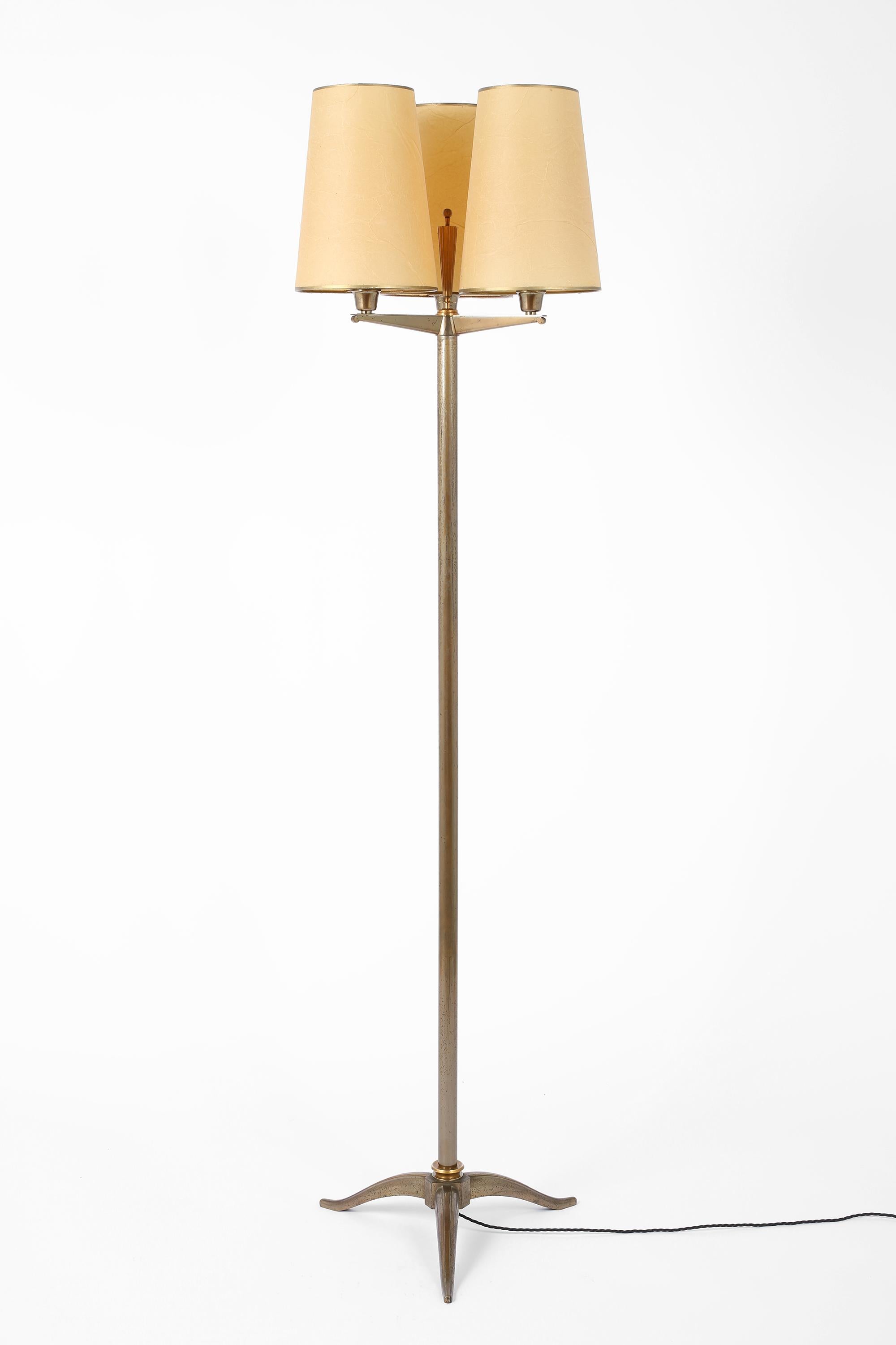 A fine Art Deco three headed bronze floor lamp attributed to Phillipe Genet & Lucien Michon. Of the highest quality; partially gilt with its original parchment shades. French, c. 1930.