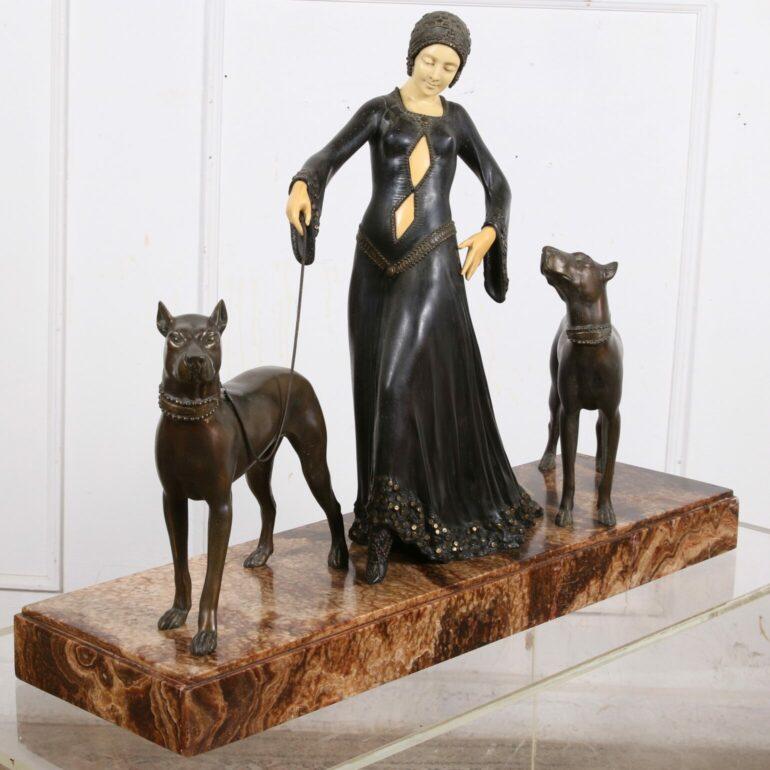 This impressive Art Deco sculpture, crafted by Georges Gori in 1920, portrays a woman elegantly walking her two massive dogs. Aptly titled “The Guardians,” it captures the essence of strength and grace in both the human and animal forms. The woman’s