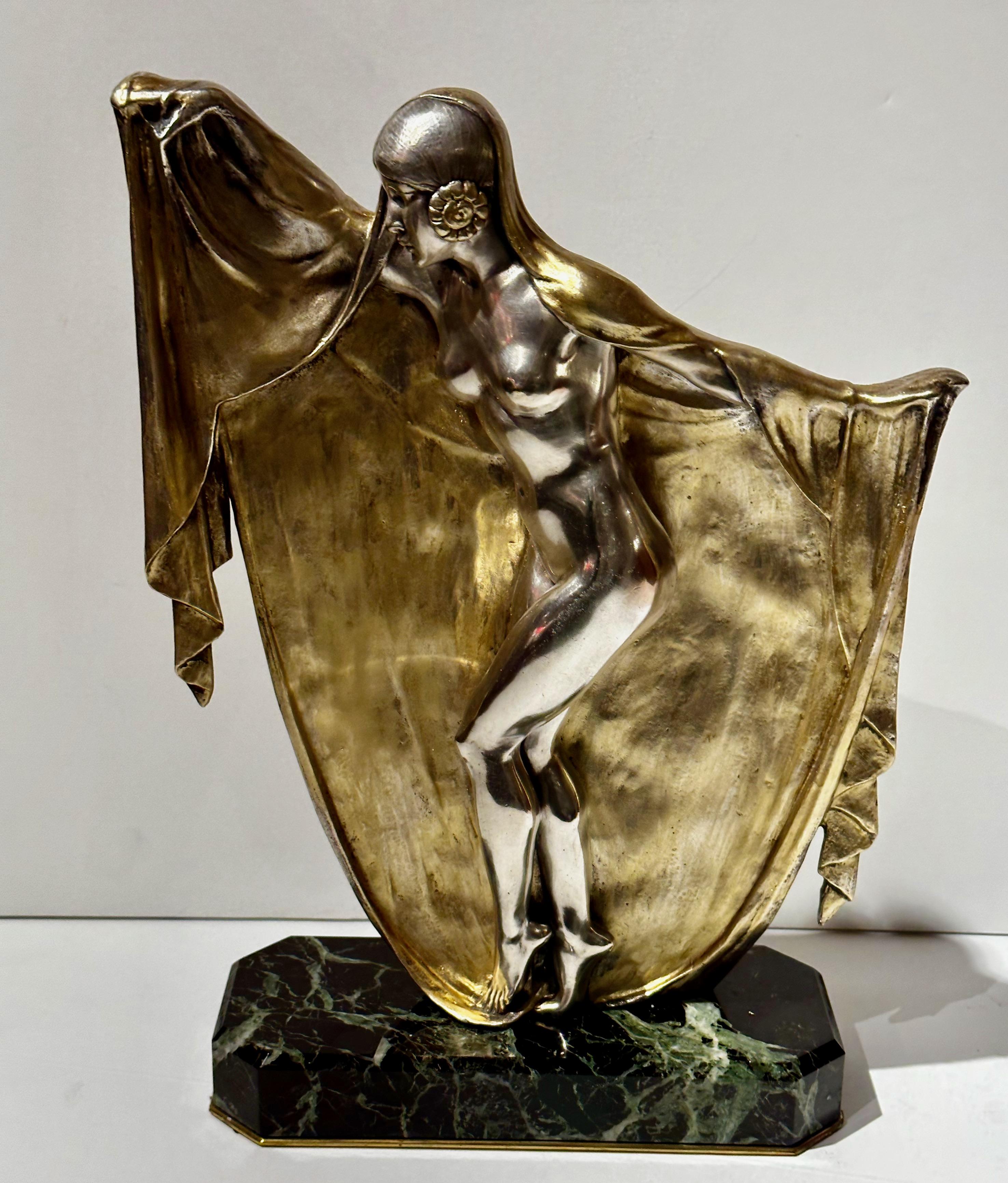 Bronze Art Deco Veil Dancer mounted on marble by Armand Lemo. This sculpture depicts a dancing woman in the Art Deco style, with a veil-like element incorporated into the design. This double-patinated finish uses bronze, gold, and silver, a