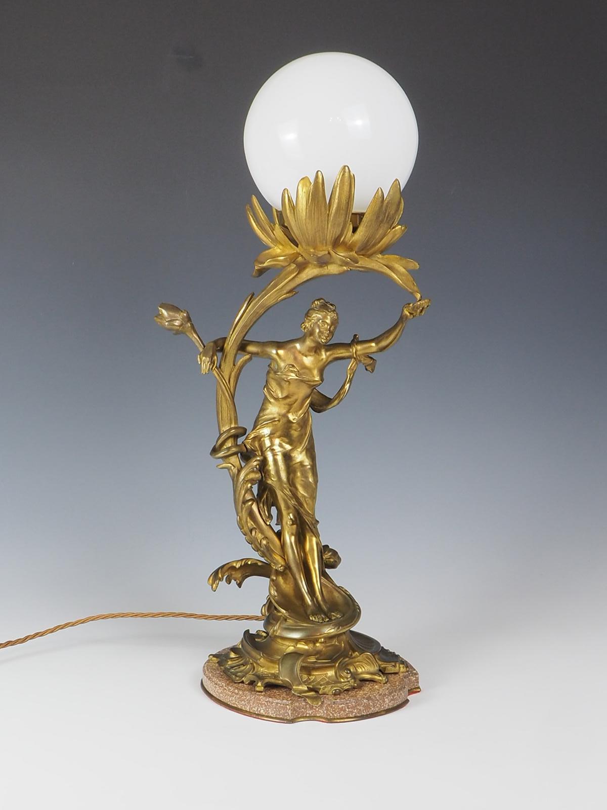 Elegant Bronze Art Nouveau Lady Antique Table Lamp, a captivating piece that seamlessly blends elegance and history. This exquisite lamp showcases the timeless beauty of the Art Nouveau era, guaranteed to add a touch of sophistication to any