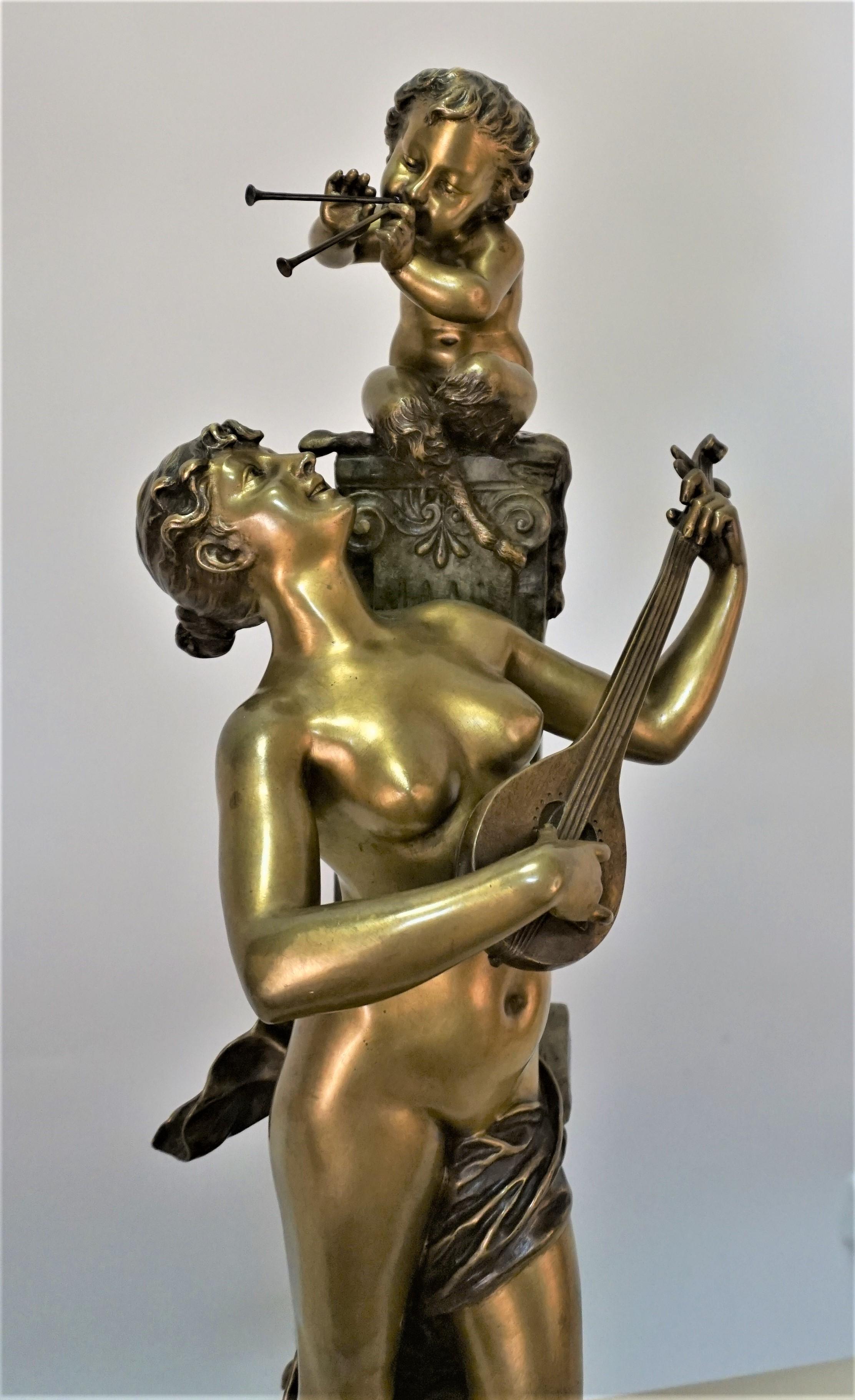 Beautiful two tone bronze patina of young woman playing music with young satyr by Italian Artist Aristide De Ranieri lived in France.