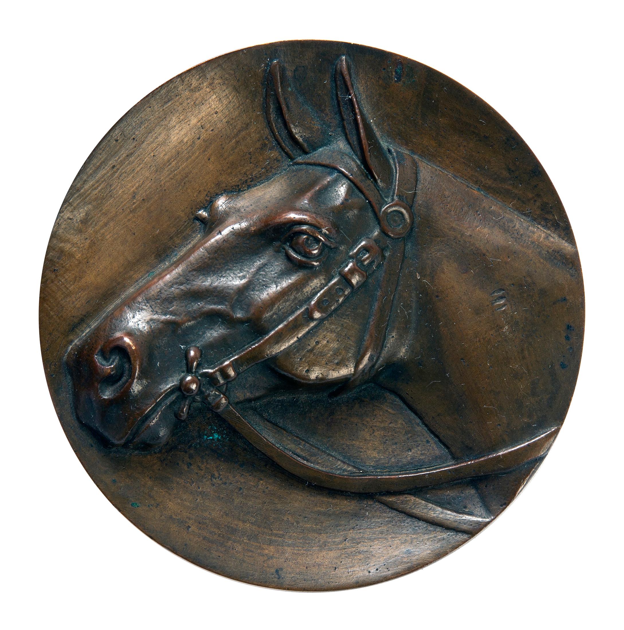 A stunning example of a refined & detailed head of a Thoroughbred, bas-reliefin bronze.
A plaque/medallion has a hook on the back for easy hanging.
Not signed by the artist.