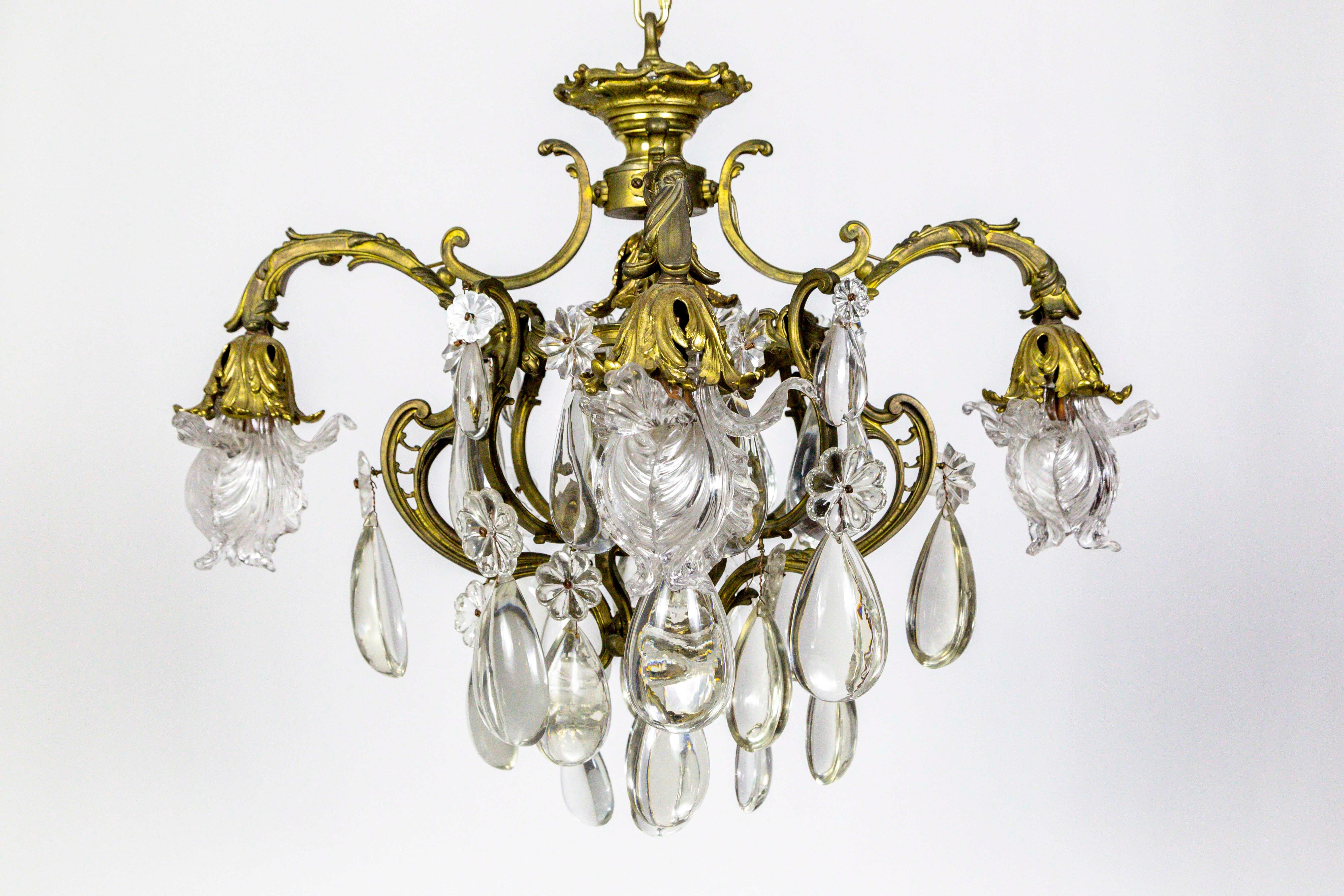 A mesmerizing, French, Belle Époque, 5-light, heavy bronze chandelier with major smooth, half-back, almond, crystals and gorgeous, Art Nouveau influenced, swooping, leaf and vine structure; also detailed with rosette and star crystals. All the