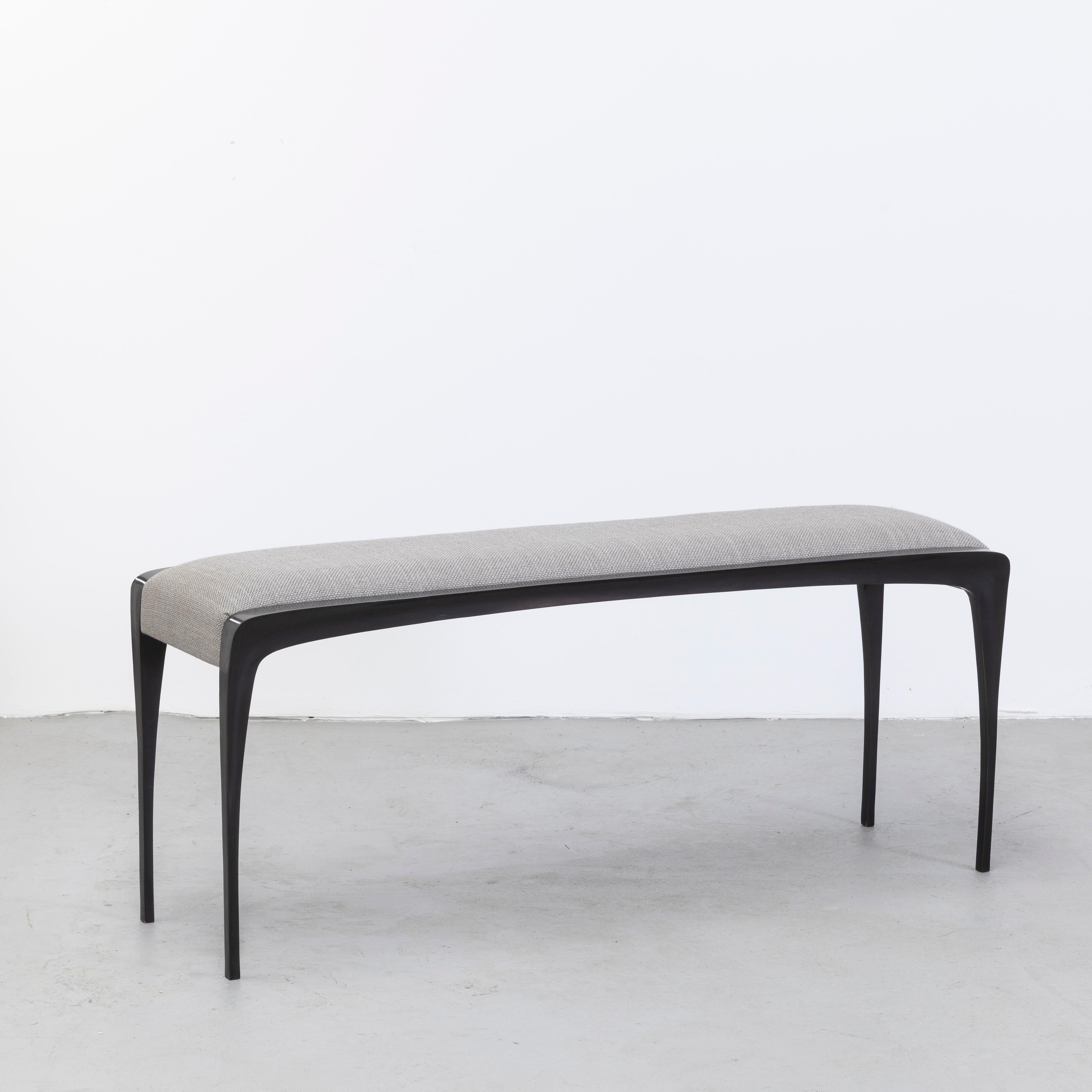 Elegant bronze bench with soft edges. Dark patina.
Elegant 2-tone bronze coffee table. 
Influenced by her studies in fashion design Anasthasia Millot creates subtly dynamic shapes that seem to defy the static of solid material. 

 Anasthasia