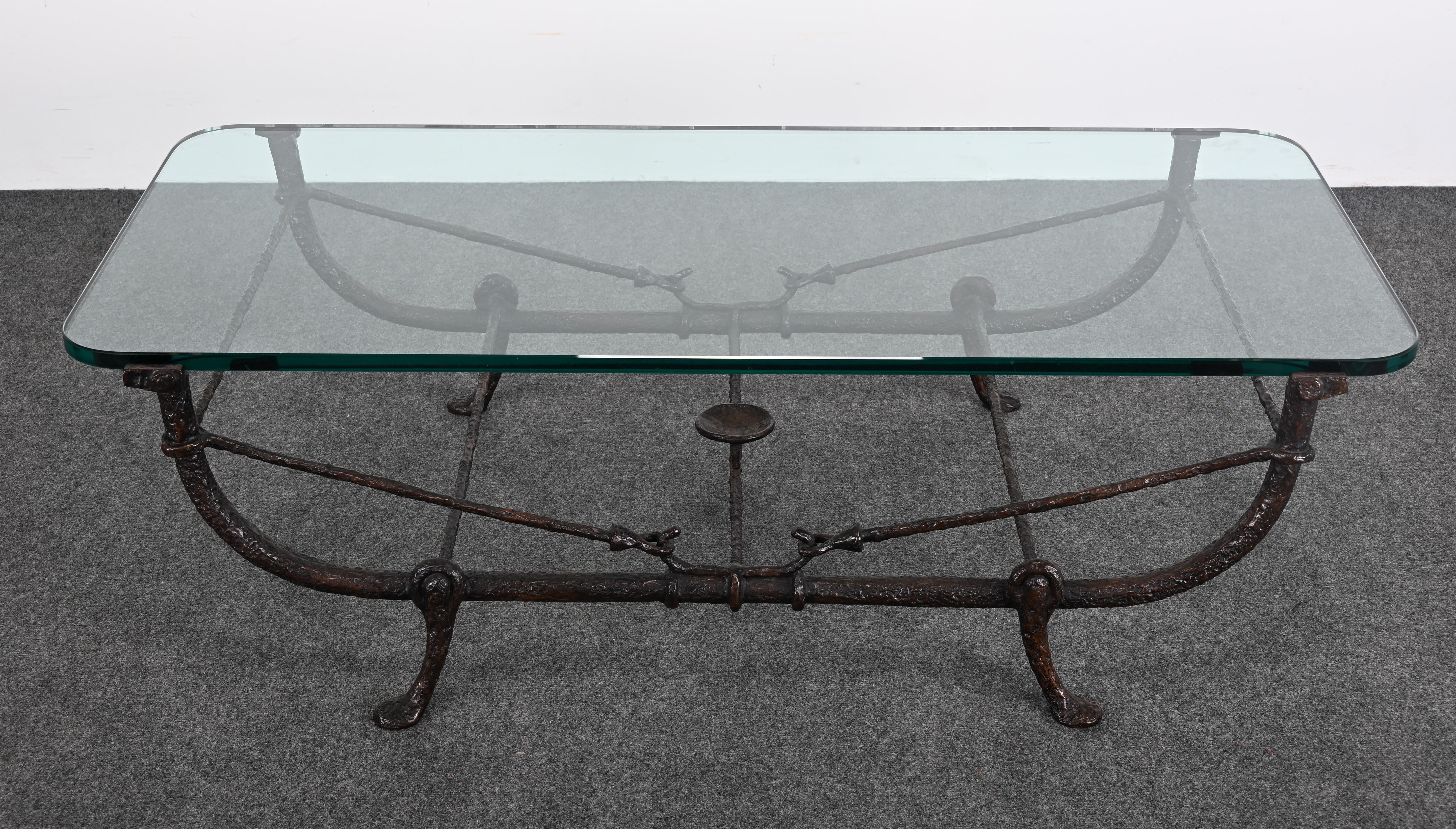 This striking coffee table, designed in the style of Diego Giacometti, captures the essence of his sculptural genius combined with functional beauty. Crafted from patinated bronze with a verdigris finish, the table features a sleek low profile and a