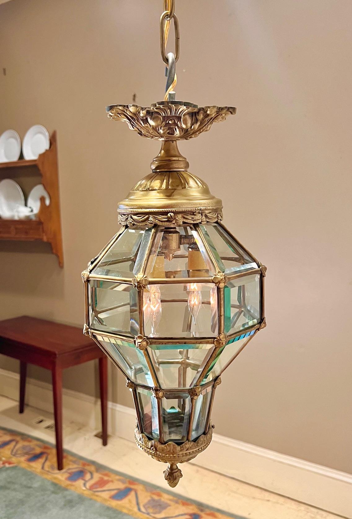 This exceptional lantern was hand crafted in Italy in the mid 20th Century. Is design harkens back to the Renaissance in Italy. Lanterns of this design were often used on ships. It is made of gilt bronze with 28 hand-beveled glass panels.. It can