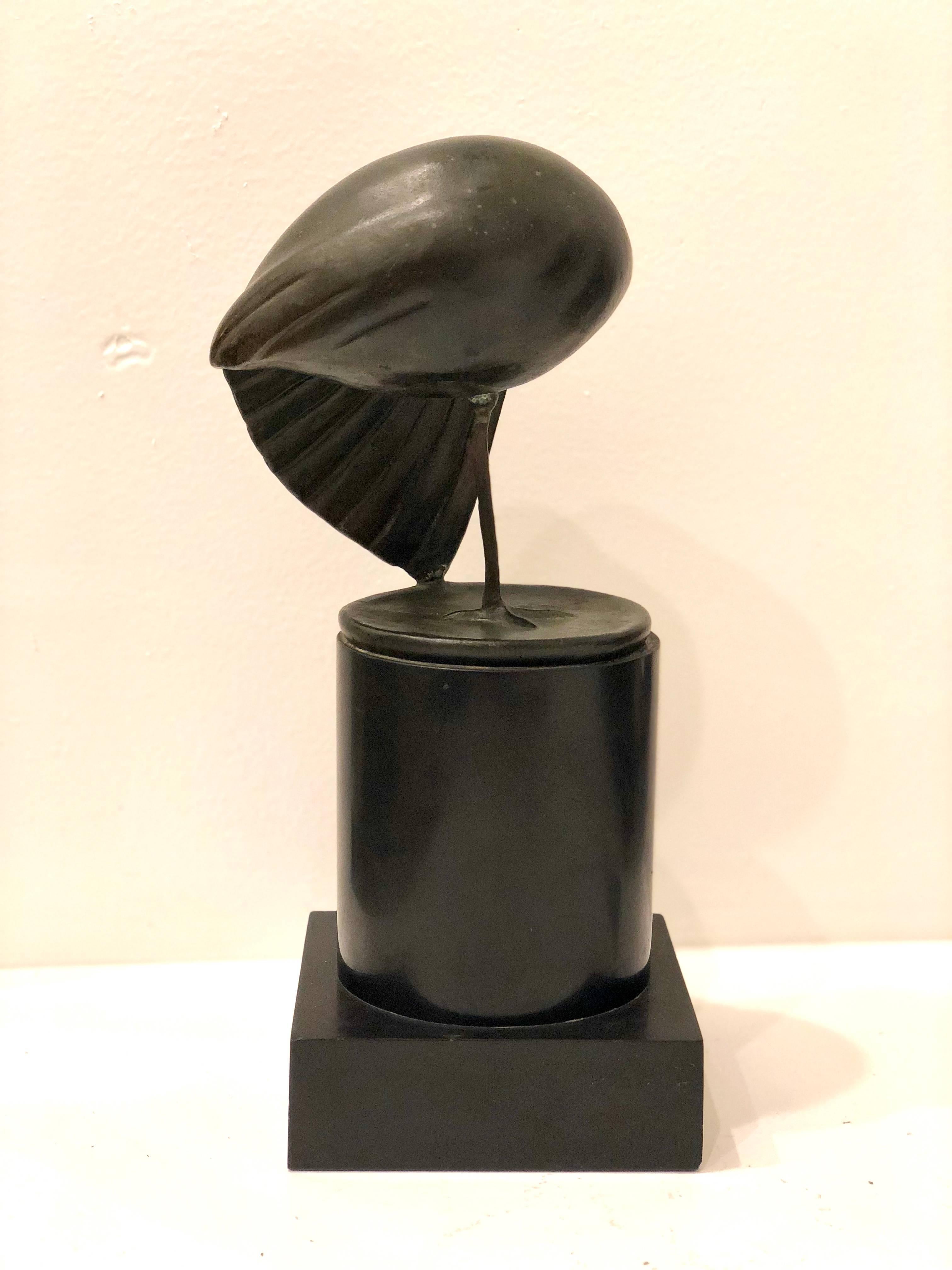Beautiful bronze sculpture sitting on solid black granite base, of standing bird on one leg stamped with foundry marks, circa 1960s.