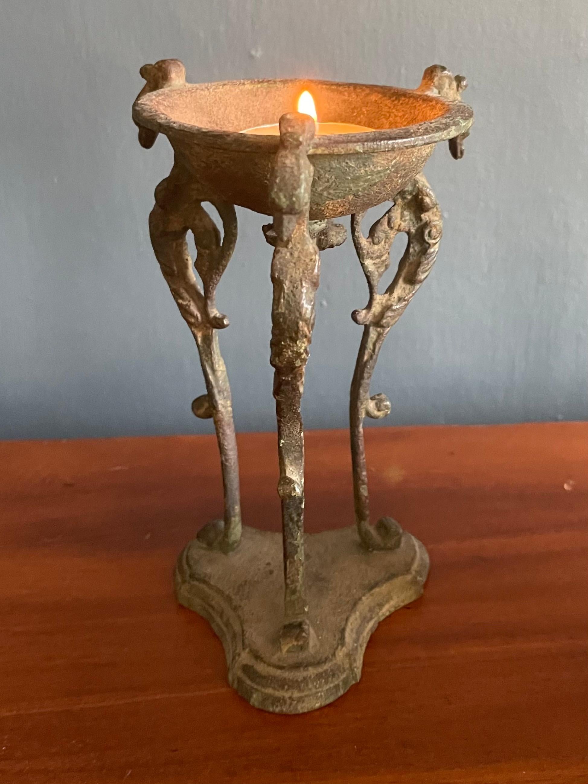 Bronze bird tripod candle stand. Antique Italian softly patinated green bronze tripod oil lamp / votive candle stand in the classical style popularized during the Grand Tour period with three figural bird figures with inward scrolling wings
