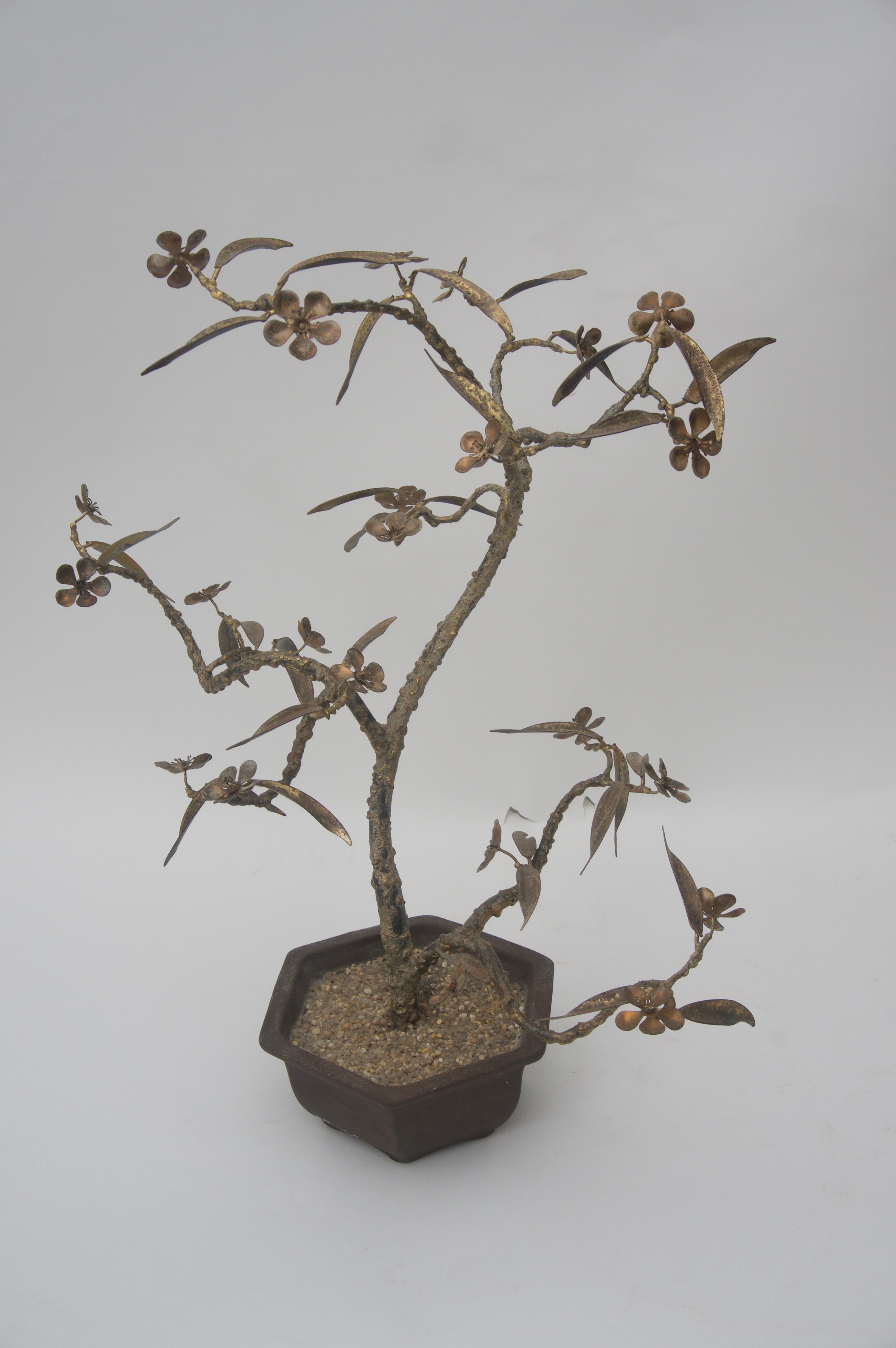 This stylish piece will make a subtle and chic statement with its refined bonsai cherry blossom tree form. The piece is signed by the artisan but unfortunately were not able to decipher the signature.