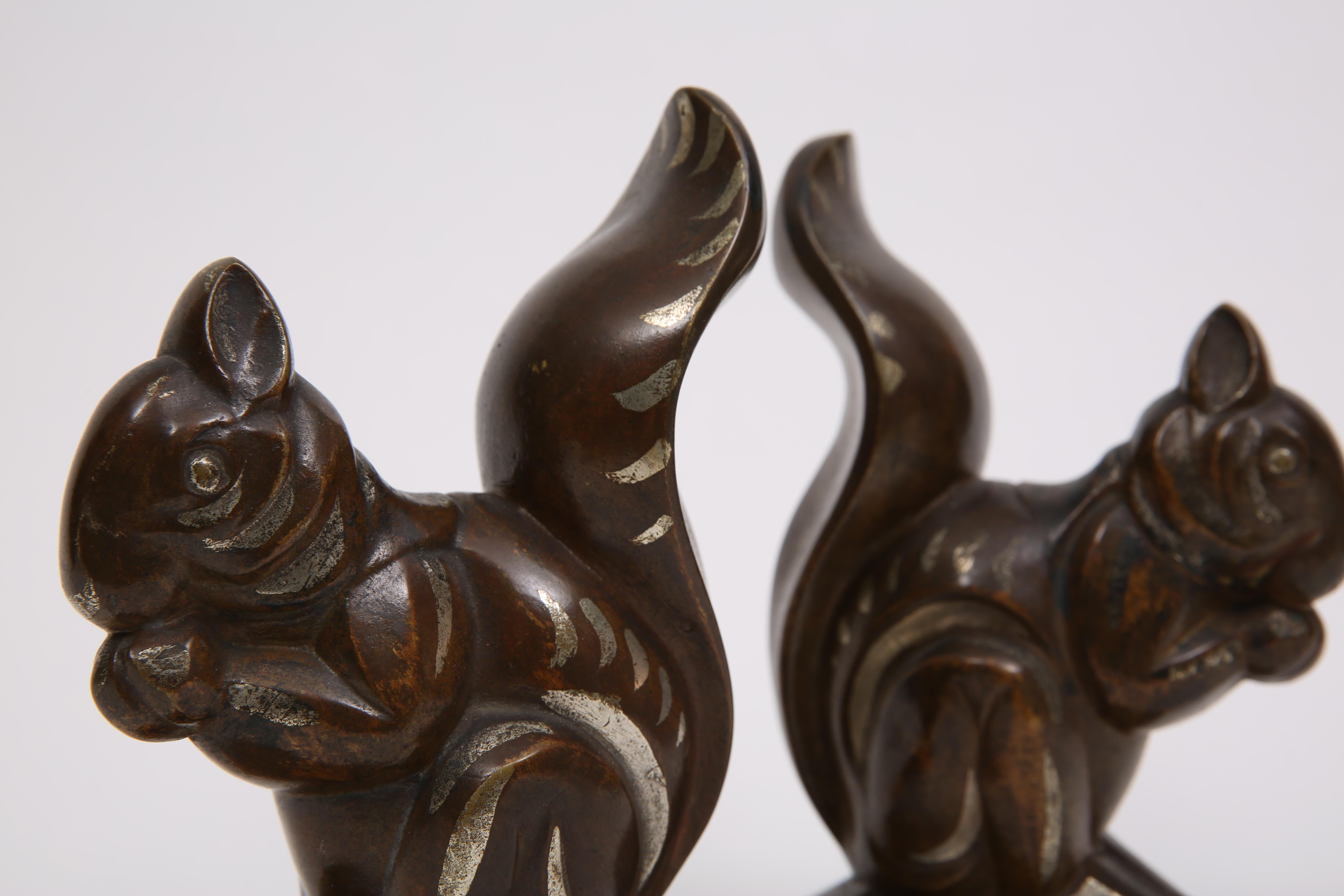 Coppia di fermalibri in bronzo policromo Art Déco raffiguranti scoiattoli di Louis Fontinelle (1886-1964). Firma Fontinelle.

Francia, CIRCA 1930.