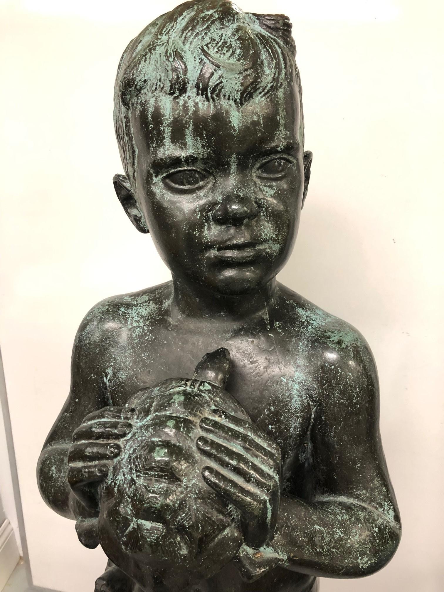 Bronze boy holding a turtle signed by Edward Fenno Hoffman III 1916-1991 American. Beautiful bronze statue of a boy holding a turtle it would look fabulous in a garden or a focal point in a backyard or patio. The statue stands 45