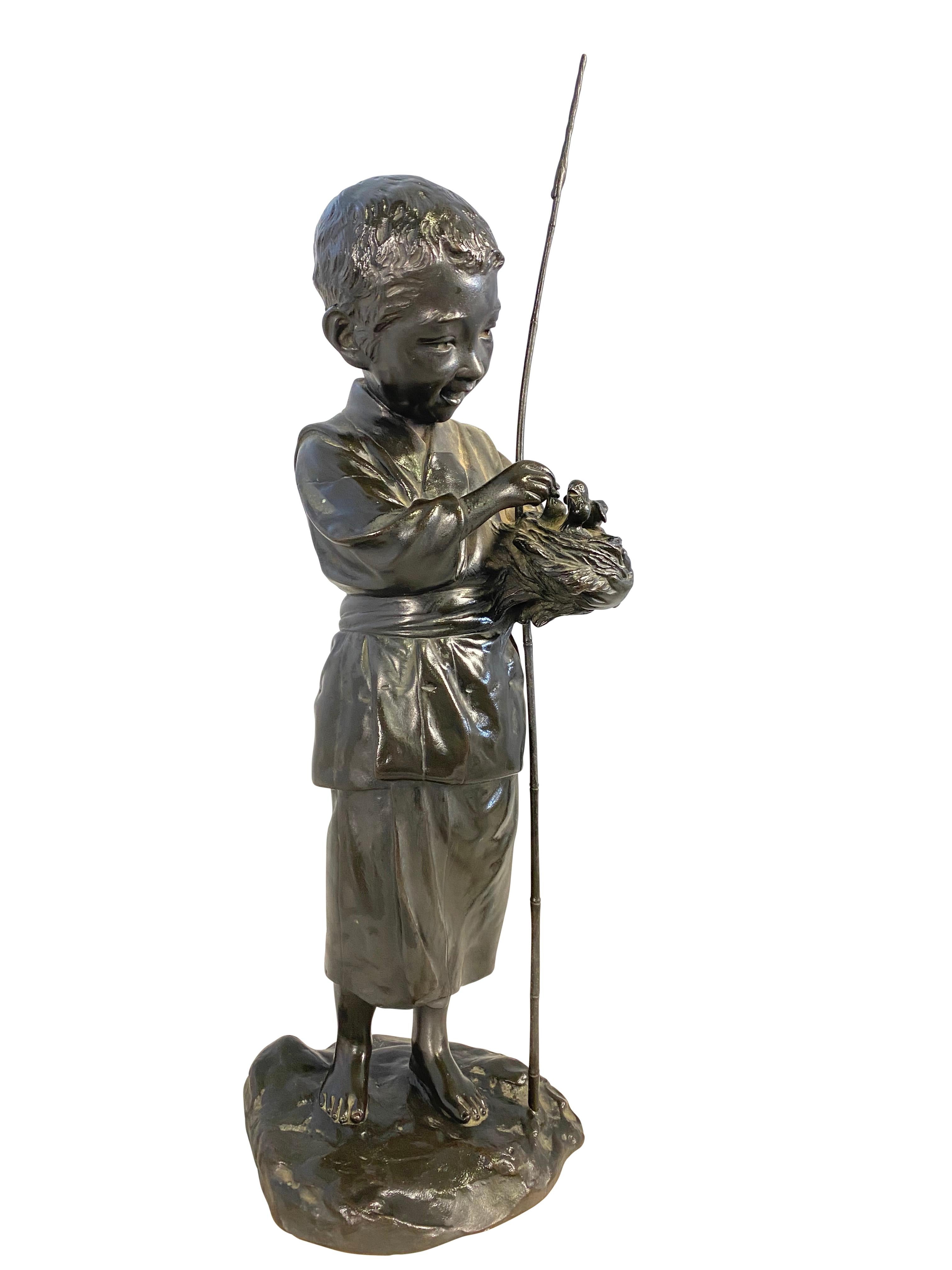 Bronze figure of a boy on a rounded base, holding a bird nest and stick. Eye-catching and timeless decoration for a relaxing ambience in the home and garden. A collector's item for antique and nostalgia for your home or garden.

Dimensions