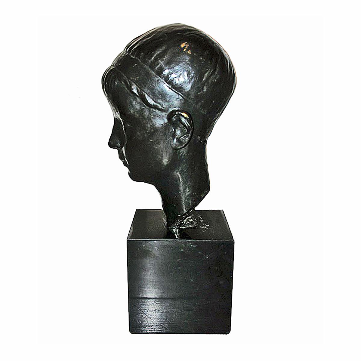 A bronze head of a youth in bronze with black patina, on a black marble pedestal, circa 1935. 

By Alexandre Wolkowyski, Russian sculptor, 1883-1961.