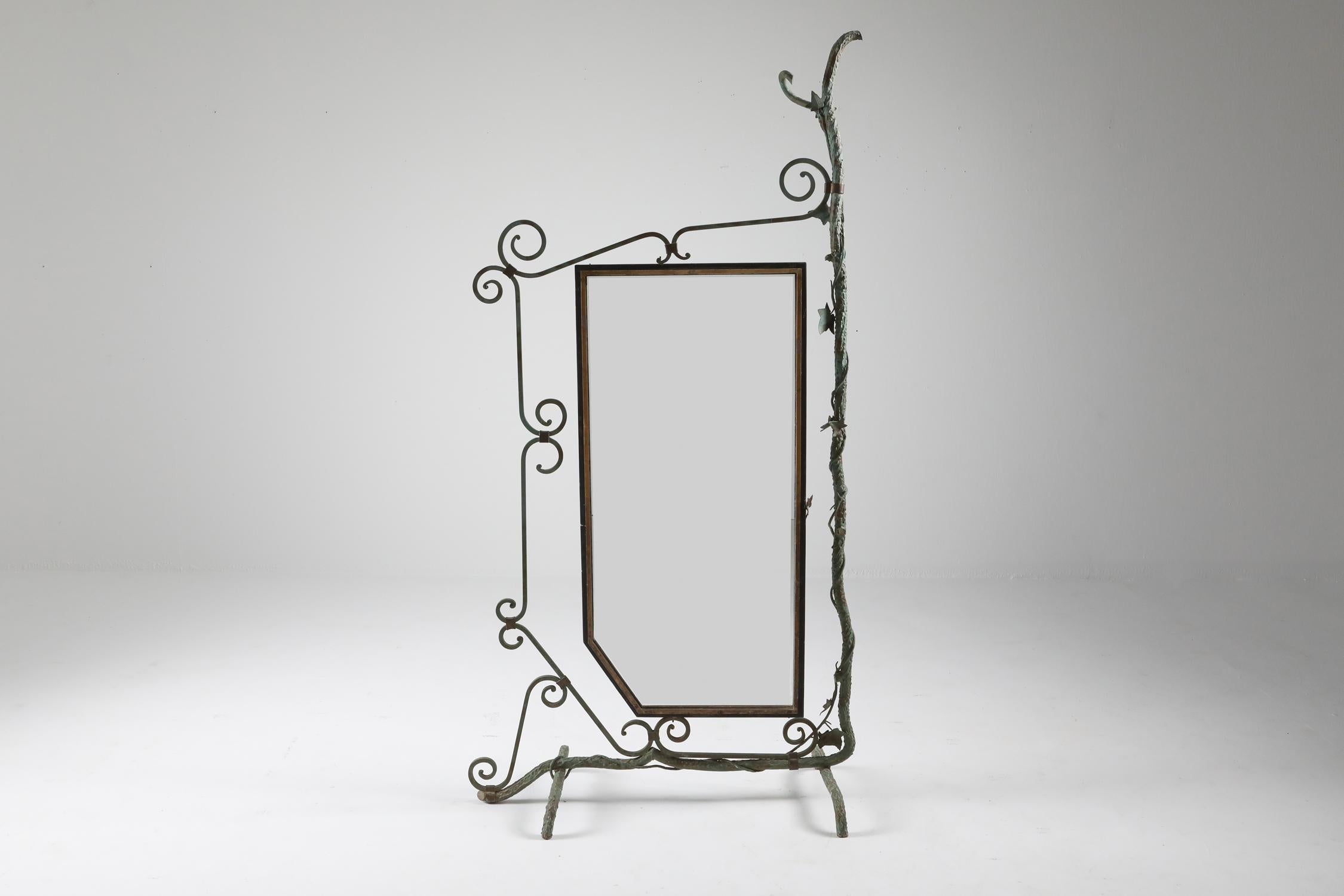 French mirror displaying a scenery of vines and leafs of grapes
Patinated forged steel 'fer forgé', brass and bronze
The mirror turns to all sides
Beautiful and elegant piece which fits in many different style interiors.
France 1920s.
