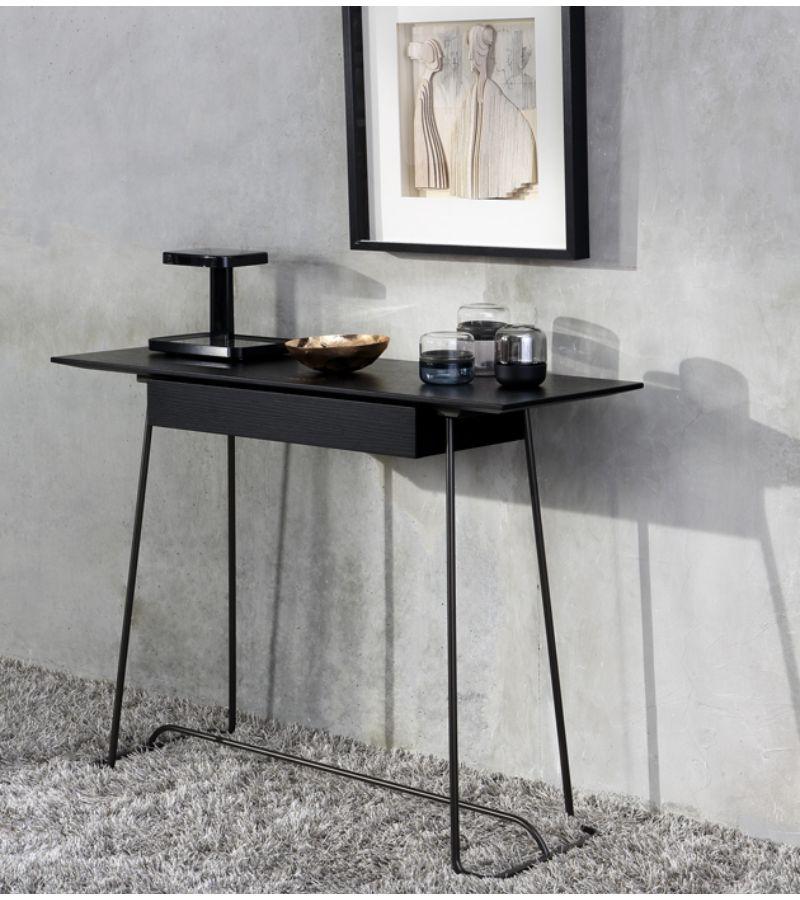 Bronze Brera Console by Marcos Zanuso Jr
Materials: Console with drawer. Base in bronze lacquered metal or chromed metal Top in walnut veneer on medium or in black lacquered oak on medium
Technique: Lacquered metal, natural or stained wood.
