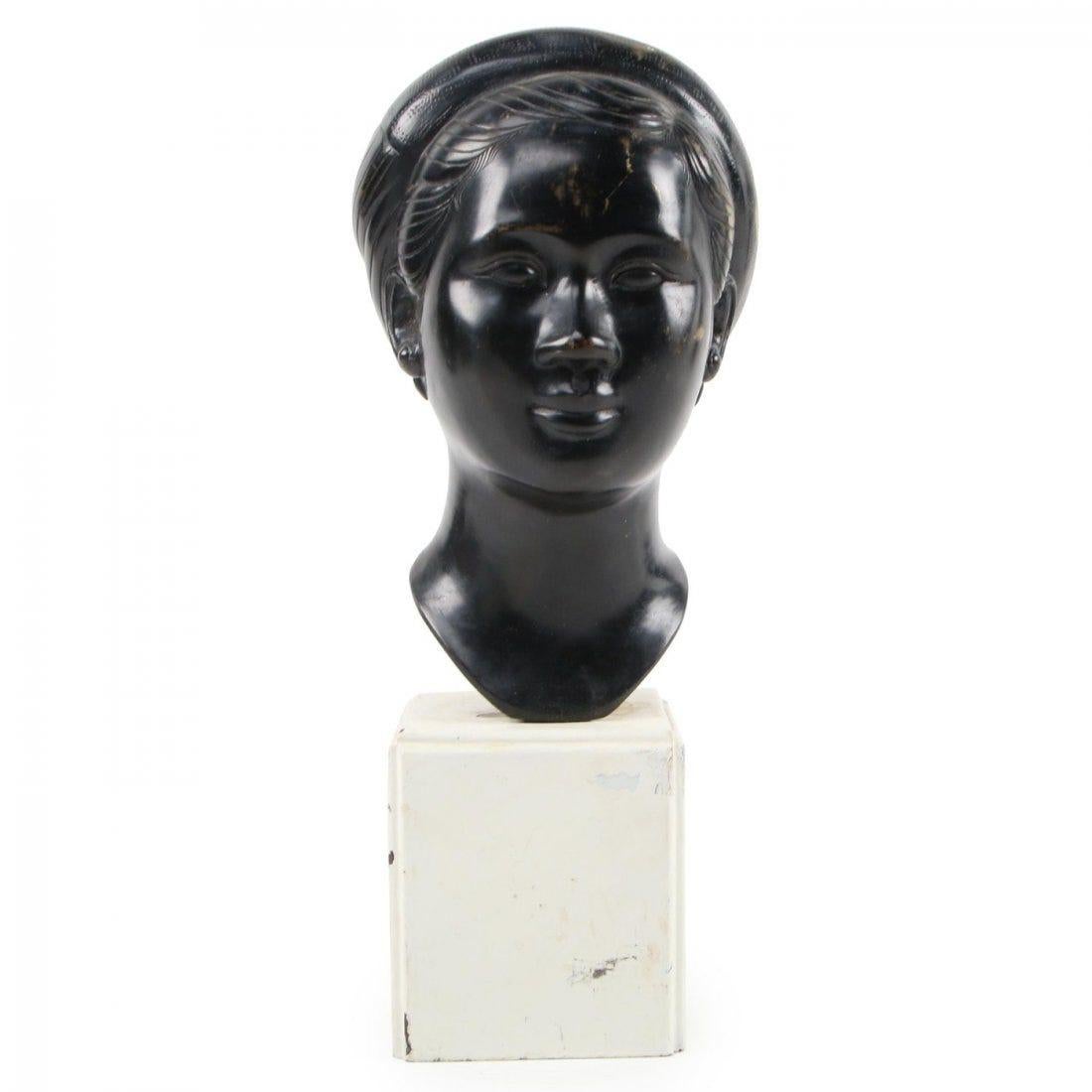 After Thanh Le Nguyen (Vietnamese, 1919 – 2006)
Untitled (bust of a young woman), mid-20th century
Bronze sculpture with black patina on wood base
Stamped to neck.

Measurements:
4.50 inches wide x 4.50 inches deep x 11 inches high