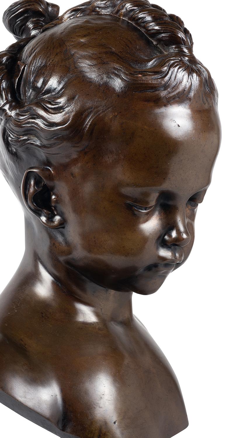 An enchanting 19th century French patinated bronze bust of a young girl, circa 1860.