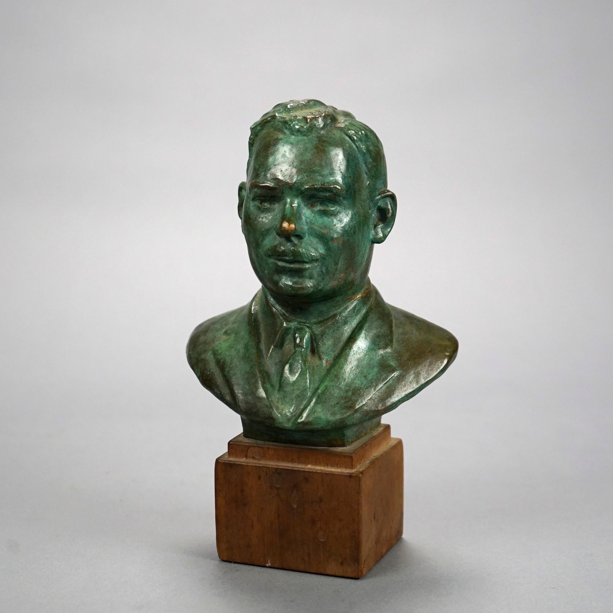 A portrait sculpture offers cast bronze bust of a man mounted on wood base and signed John Terkeni, 20th C

Measures- 8.25''H x 5''W x 3.25''D.
