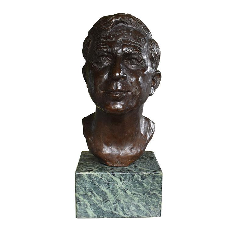 A large striking bronze bust sculpture of a man with the likeness of Will Rogers. This piece was created by Leonard McMurry, also known as Oklahoma’s “Michelangelo”. It stands on a green marbled stone square base. 

The sculpture depicts a man,
