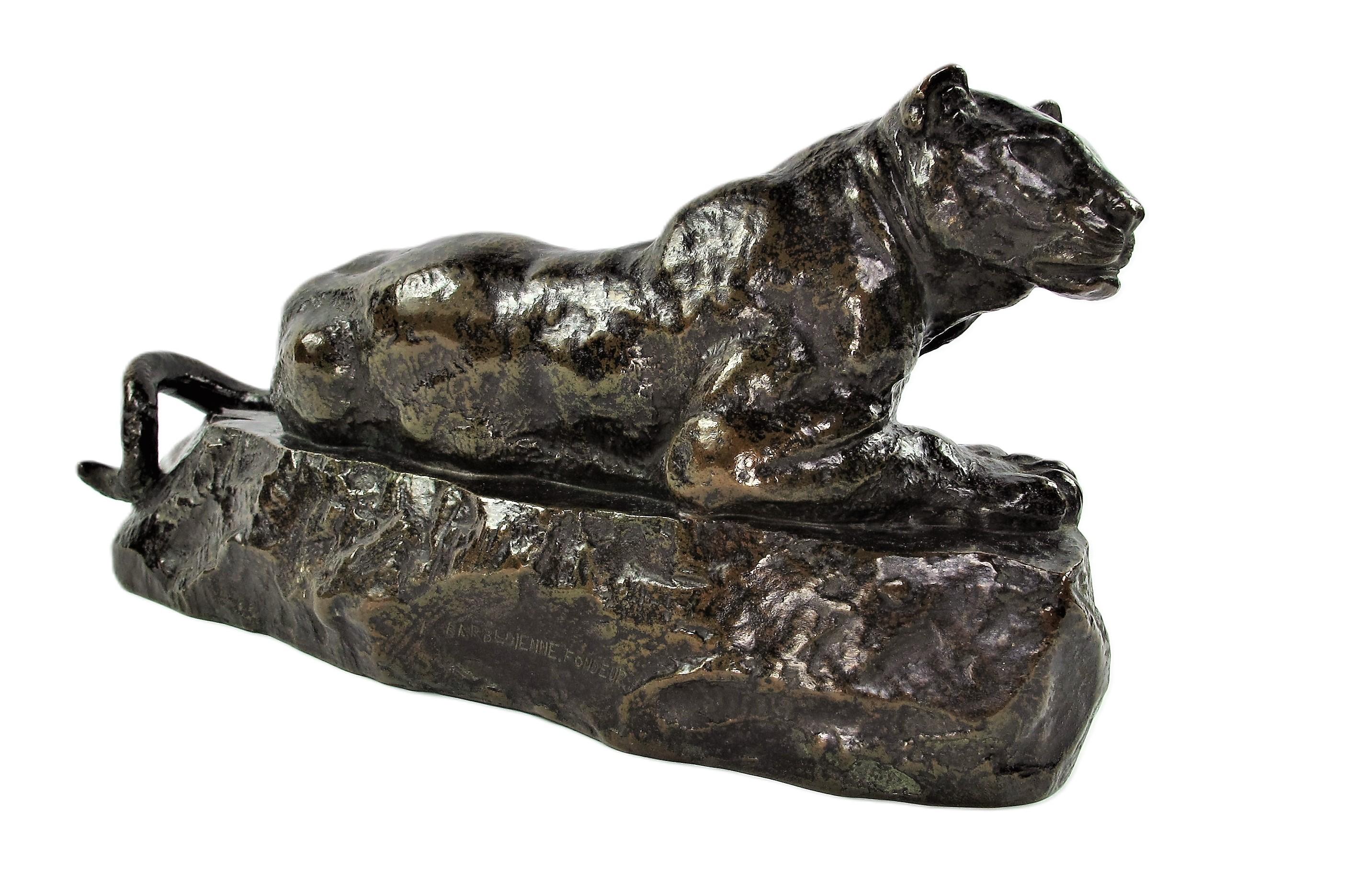 Very beautiful bronze proof with brown patina nuanced with black representing an observing panther, crouching on a rock. Old proof signed BARYE on the side of the terrace, at the front, on the left, published and signed F. Barbedienne Fondeur.