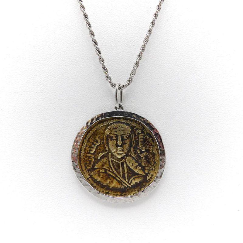 This bronze coin, also known as a folis, is from the Byzantine Era. Byzantine coins are one of the most challenging and complex coins to identify.  This coin has an image of an emperor on the front; on the reverse is Arabic script, demonstrating