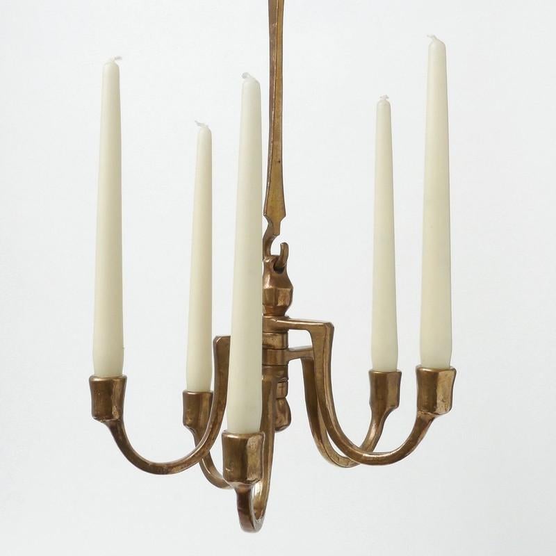 Bronze cast candelabra composed of five cast arms candle holder for regular candles. It is designed by Michael Harjes (1926-2006) and produced by Harjes Metalkunst workshop, a business Michael took over in the 1950's from his father an armorer and