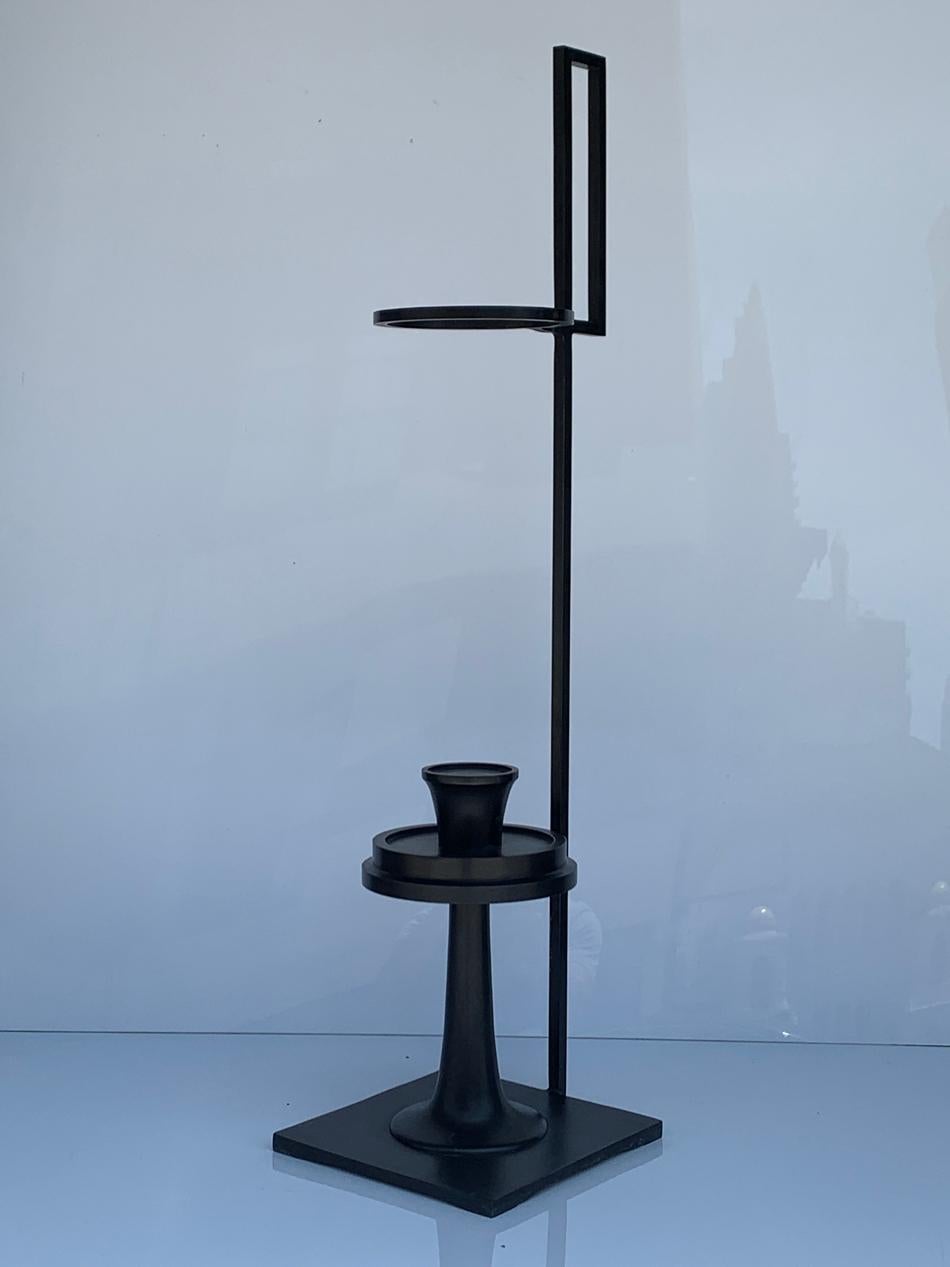 Introducing the Bronze Candle Holder by Alexander Lamont, a luxurious and exquisite piece of furniture that will add a touch of elegance and sophistication to any space. Standing tall at 30