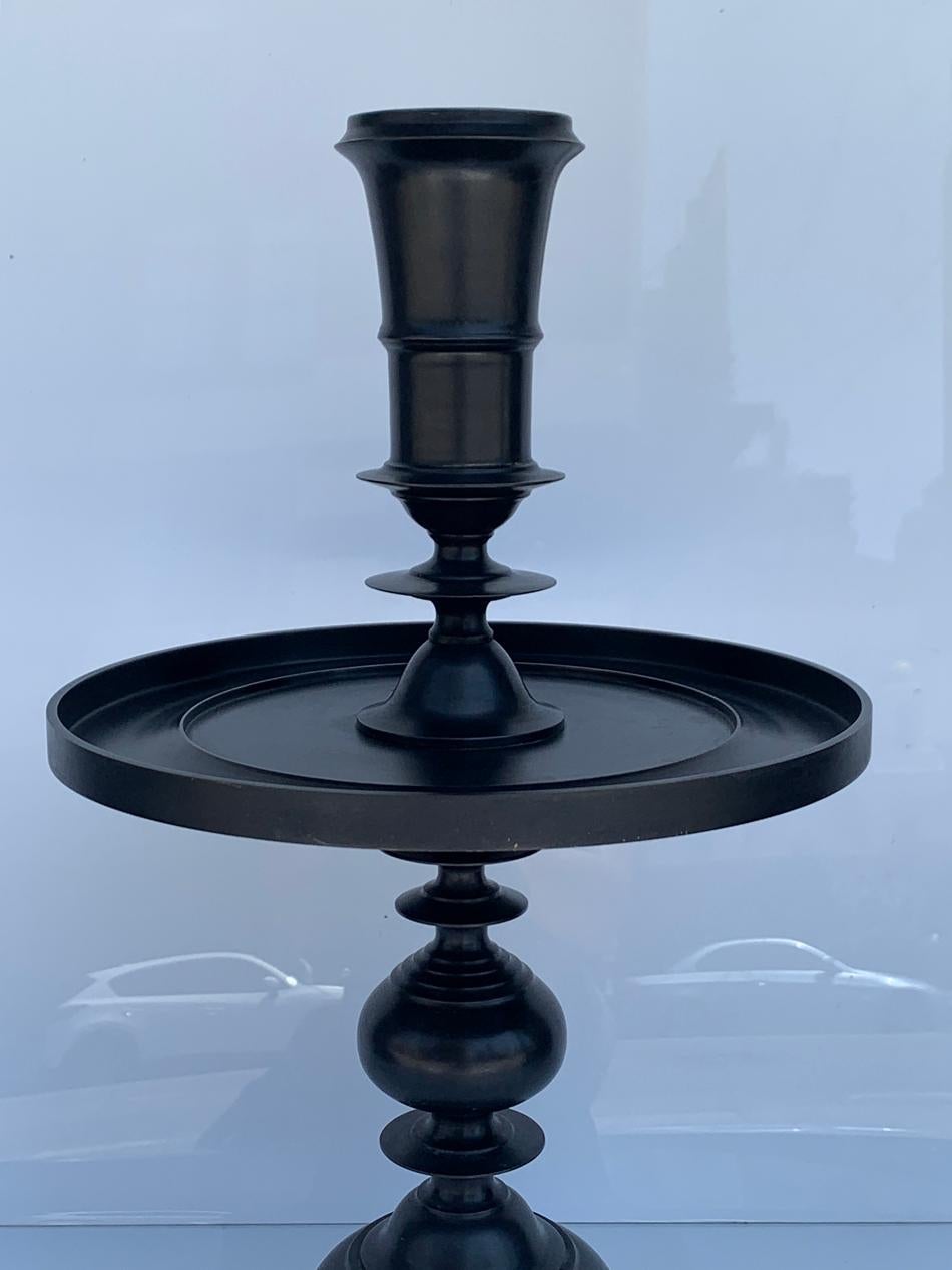 
Introducing the exquisite Bronze Candle Holder by Alexander Lamont - a striking addition to your home décor that effortlessly combines elegance and functionality. 

Crafted with meticulous attention to detail, this candle holder features a sleek