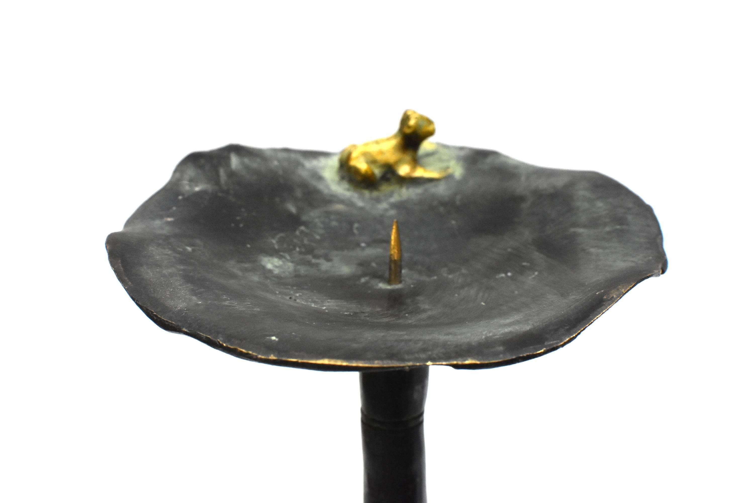 A beautiful, one of a kind, bronze candelabra. Scalloped edged lotus leave with a frog perched on top makes the piece come alive. Bamboo bodice intercepted by lotus flowers provide visual interest. Three footed bases anchored by beast motifs provide