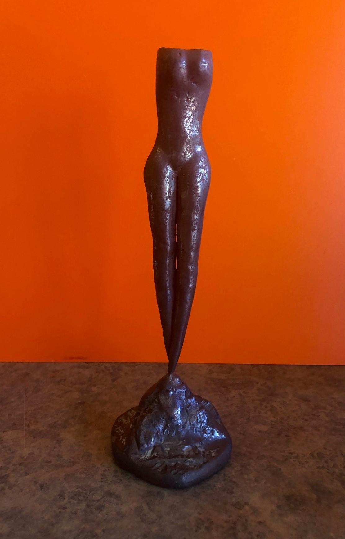 A single bronze candlestick of a nude woman by Boris Matkovski, circa 1960s. The piece is 11.25