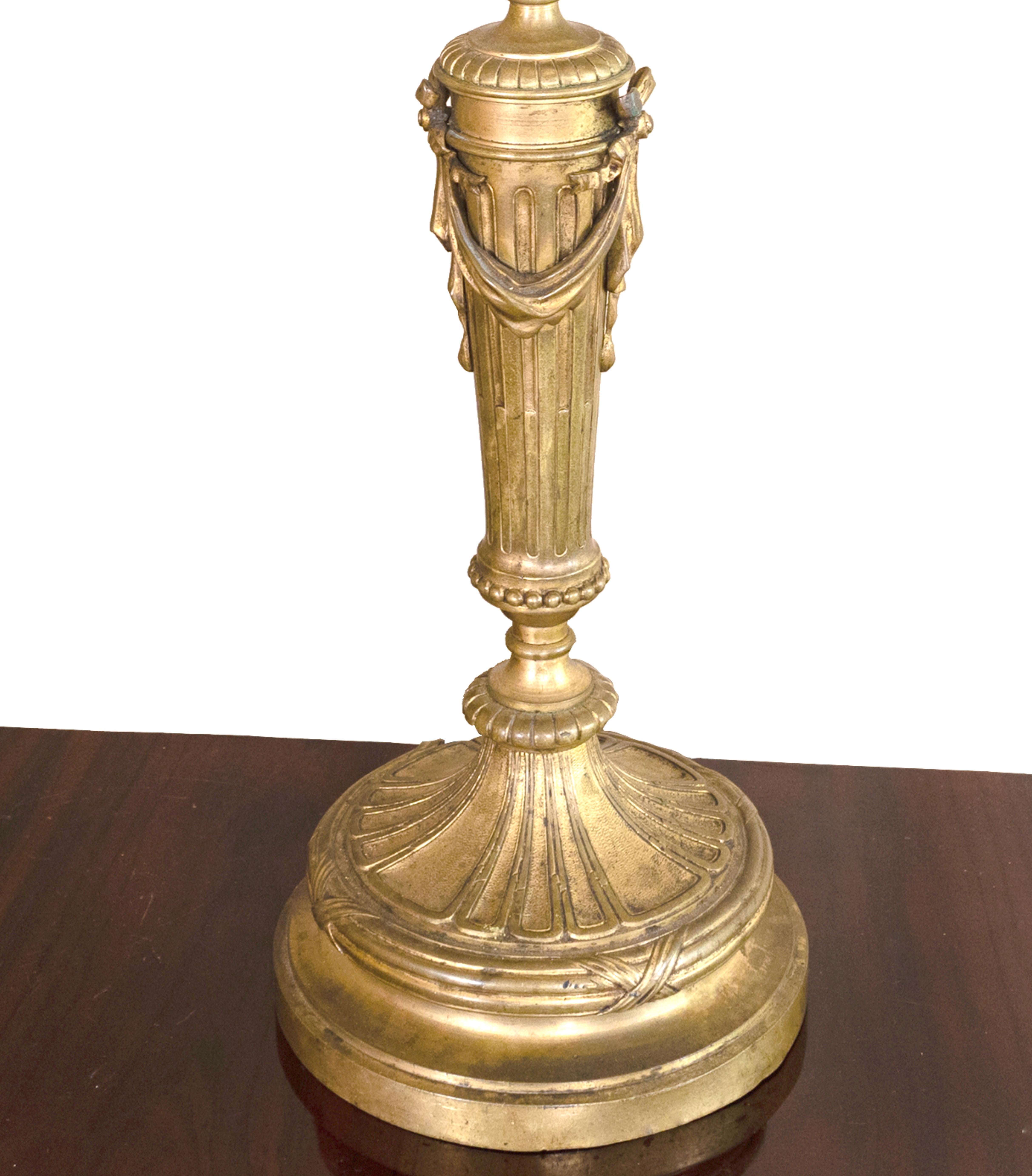 A french Napoleon III styled candlestick table lamp in gilded bronze with a new lampshade and rewired recently. Sold without abajour, if necessary can be included.