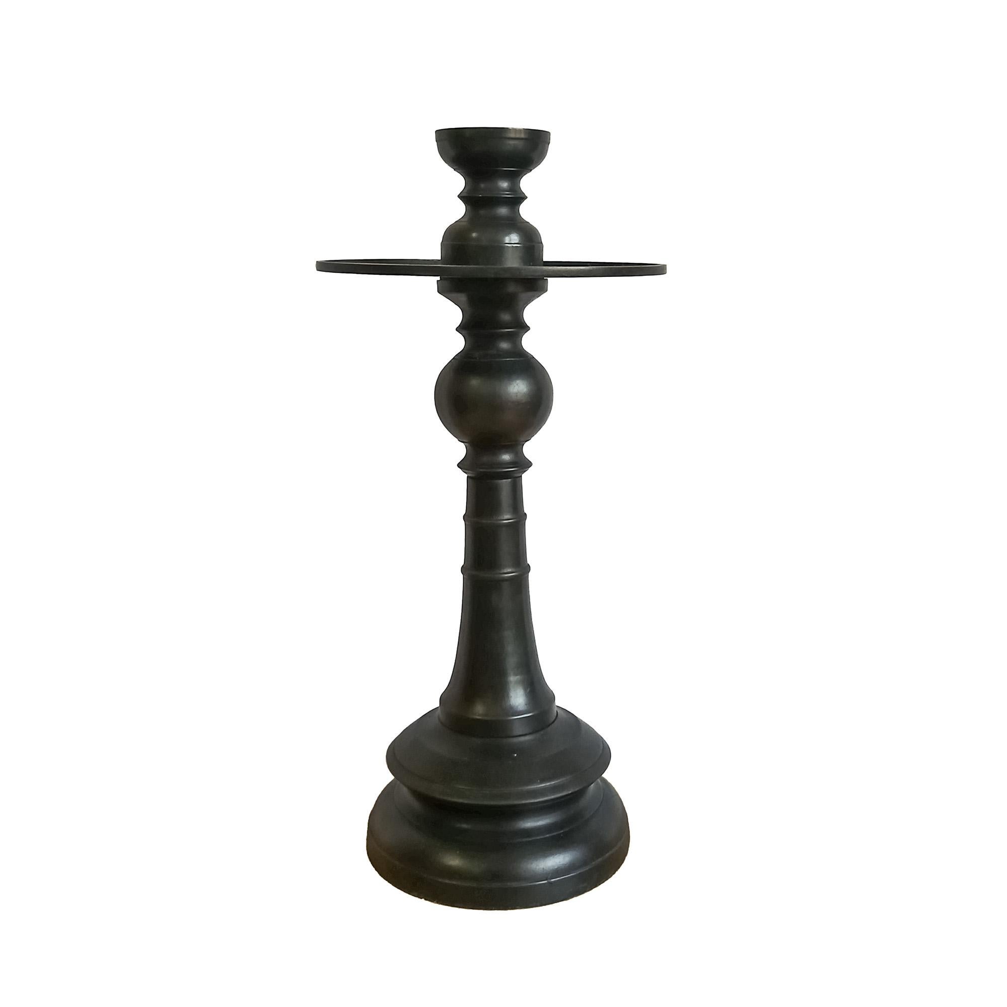 A medium-size candlestick in forged bronze with black satin finish. Indonesia, contemporary.

The 7.5 diameter top plate is designed to hold pillar candles up to 5 inches in diameter. 
It also  includes a removable top that holds candles up to 2