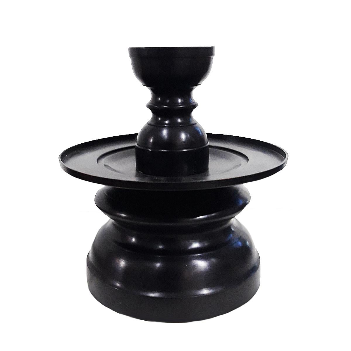 A tall bronze candlestick in forged bronze, black finish. Contemporary. The 9.5-inch diameter top plate is designed to hold large size candles, and includes a removable top that holds smaller size candles. 17.5 inches tall, with a 9-inch base. A