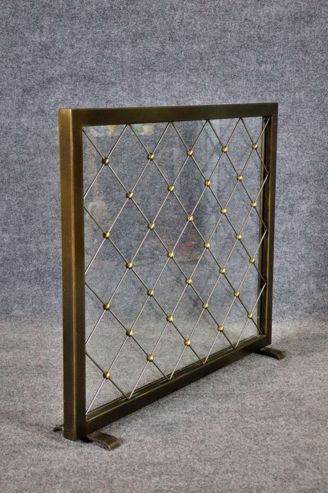 Bronze frame. Satin steel and brass details. Glass insert. 30