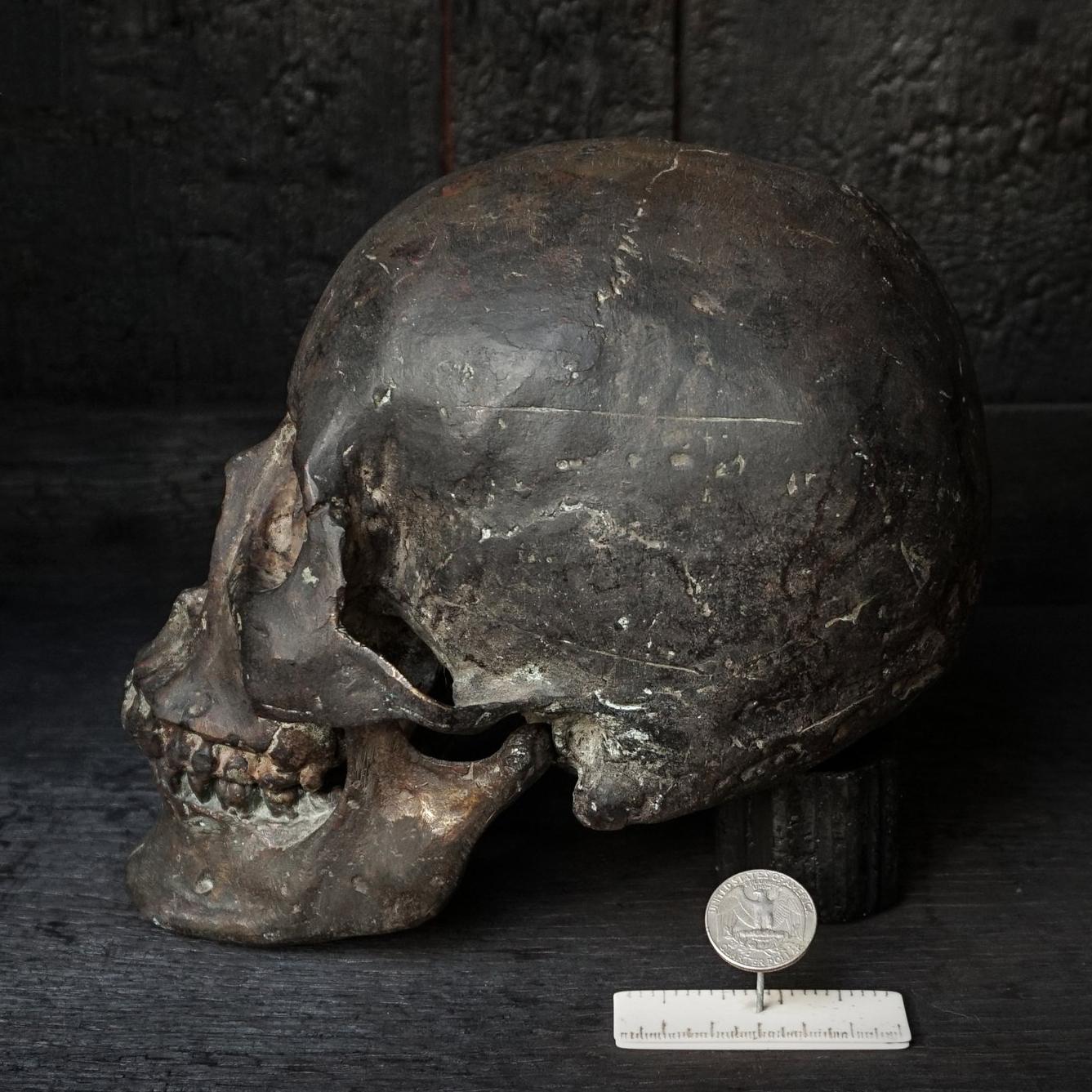 Authentic heavy and rare raw casting in bronze of a human skull, complete with lower and higher jaws. 
This skull vanity (or vanitas) could be seen as a 'memento mori' to remind people of their mortality. The model was made from a real human skull.